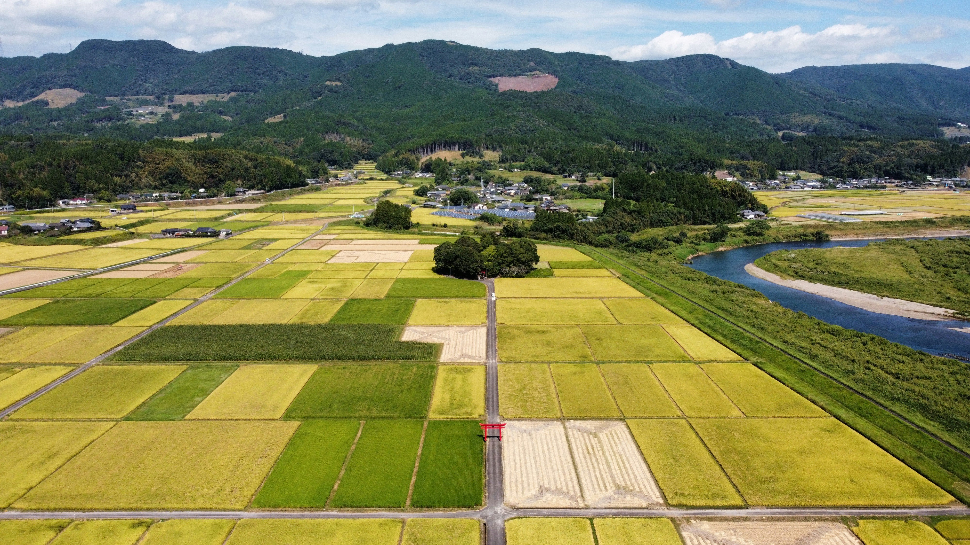 mountain valley landscape with fields and a winding river