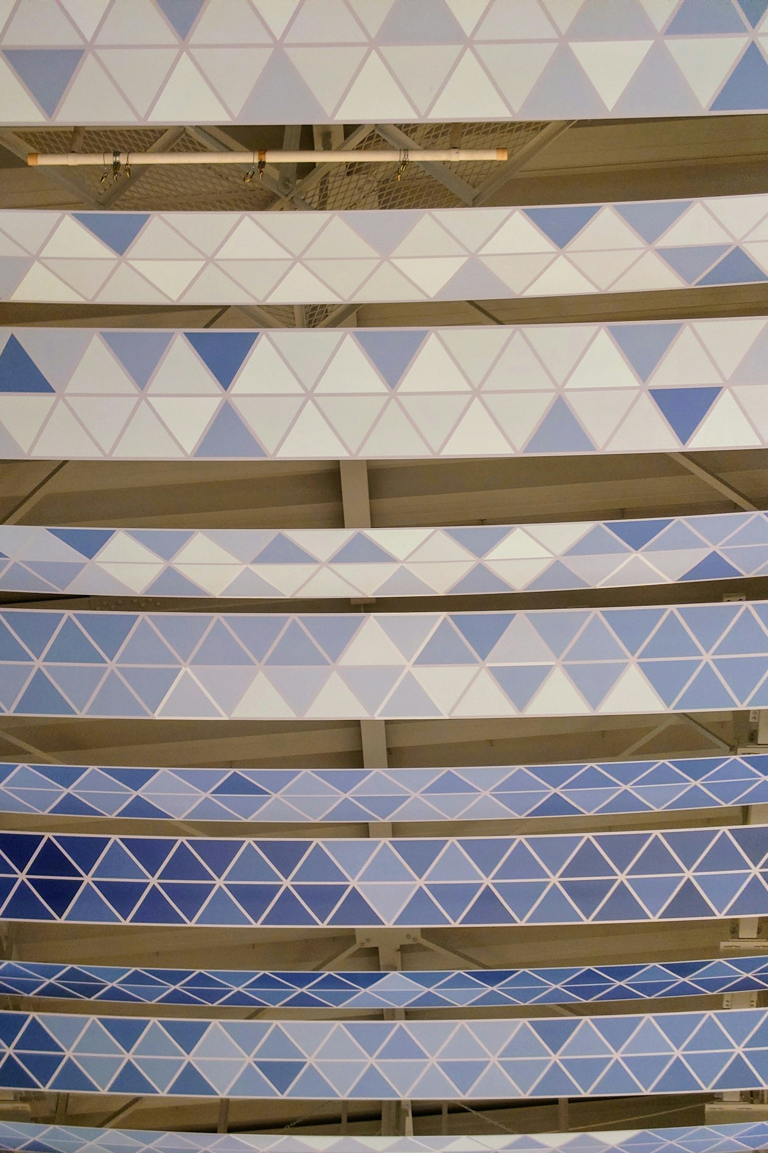 Ceiling design with alternating blue and white triangular patterns
