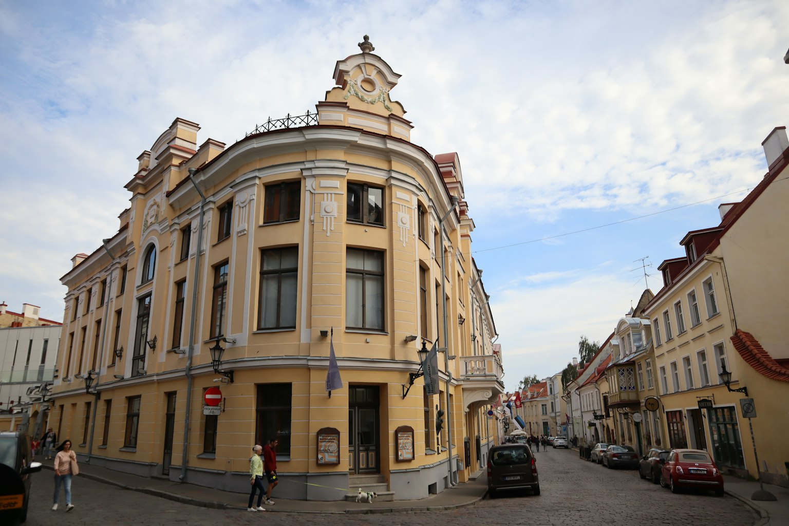 Historic building at a street corner with a bright sky