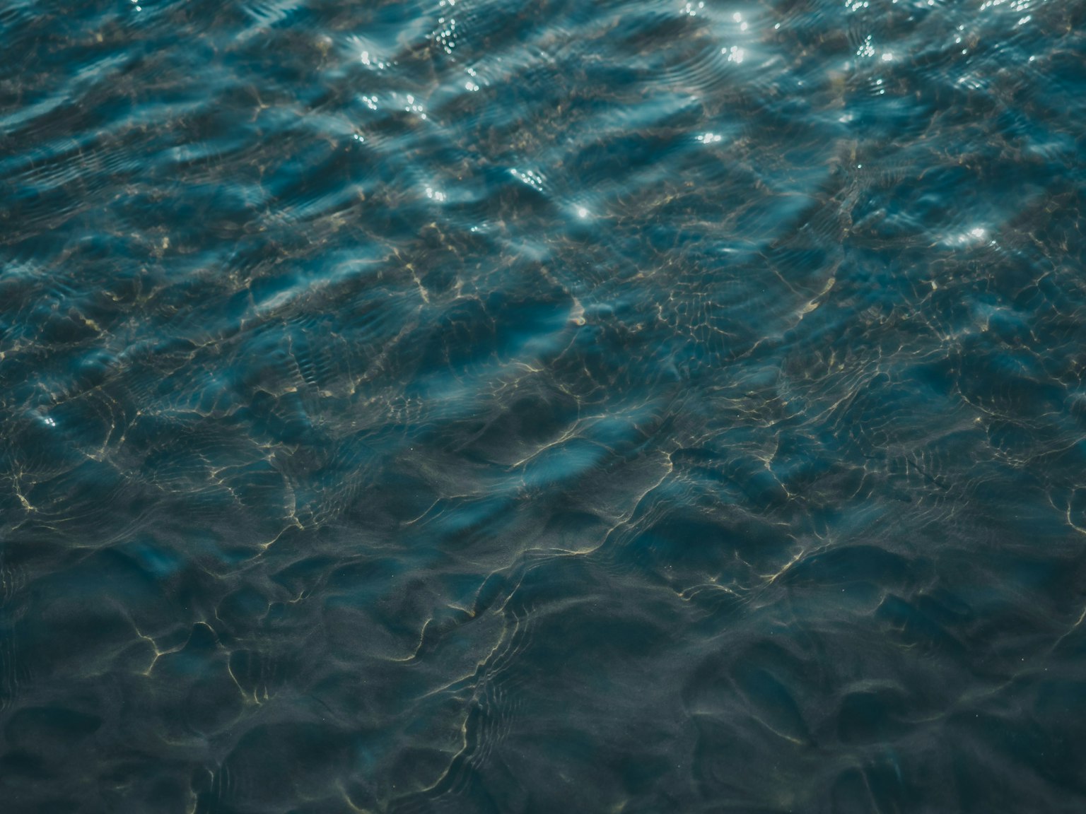 Beautiful blue water with ripples and light reflections