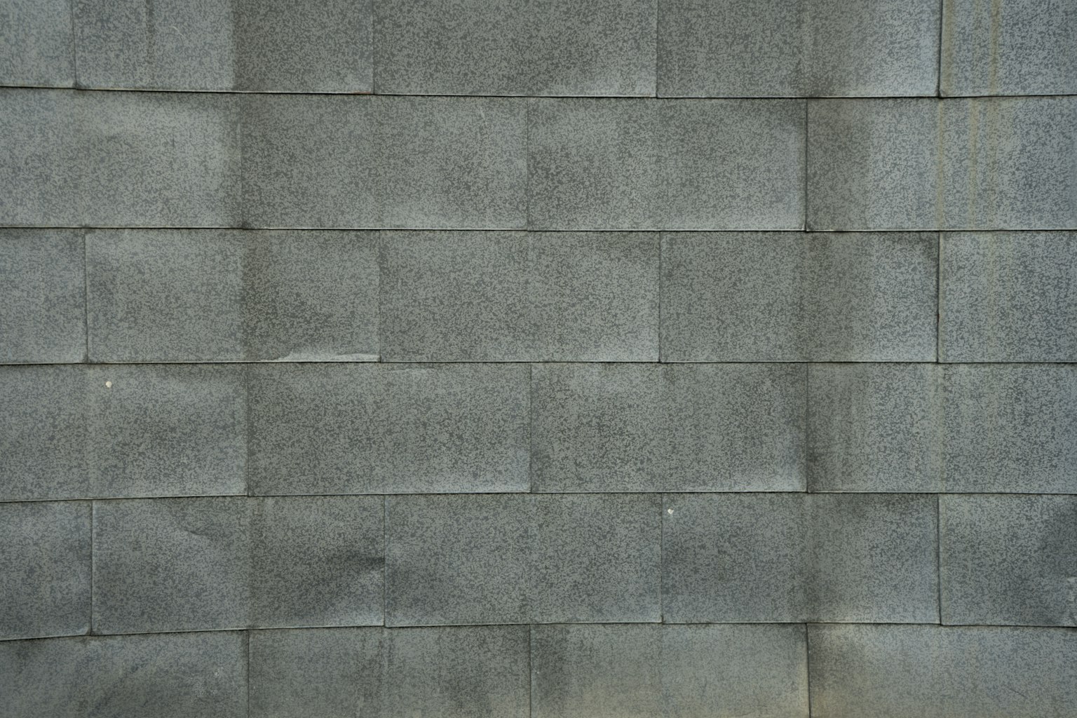 Textura de una pared hecha de bloques grises dispuestos ordenadamente