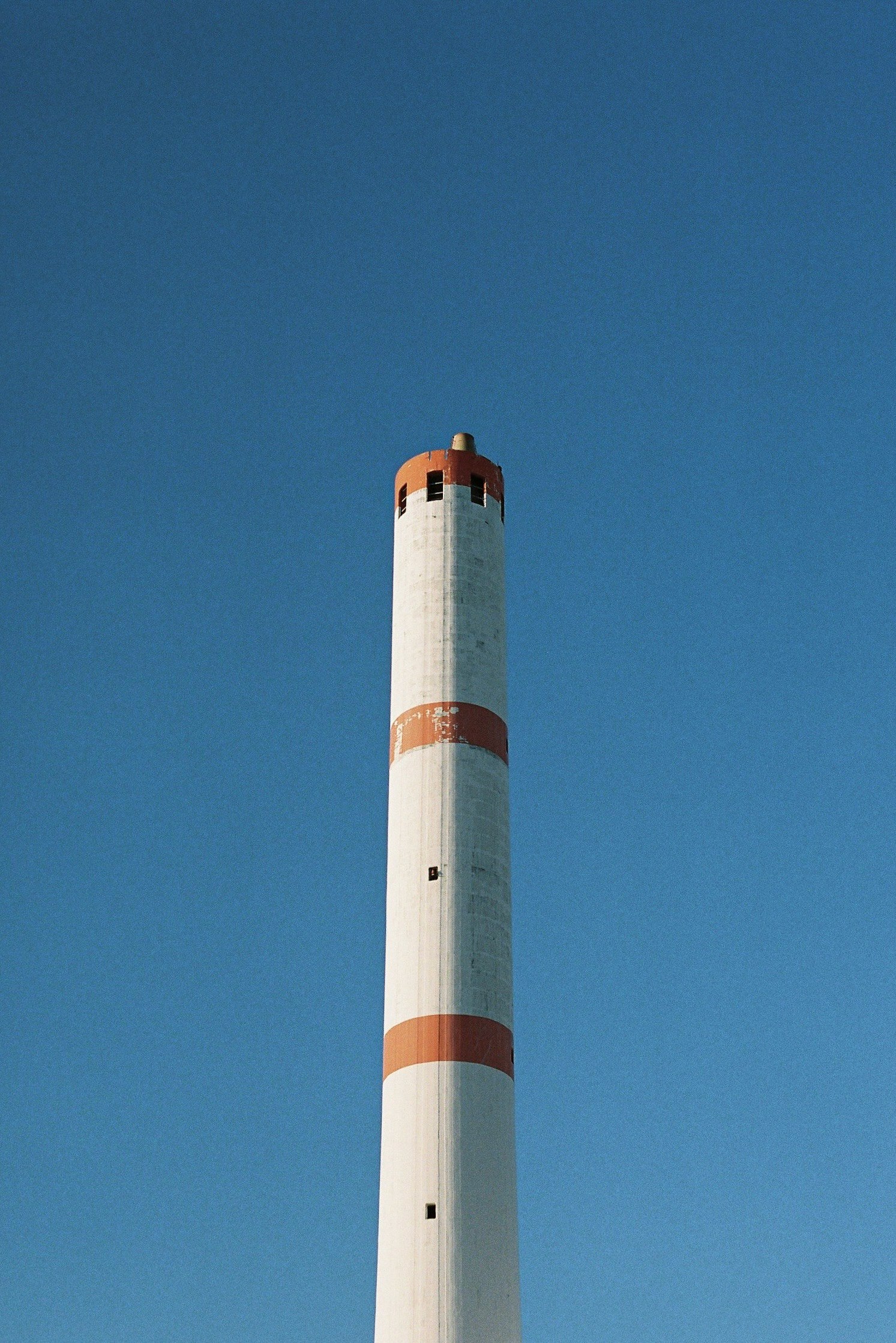 industrial smokestack against a clear blue sky
