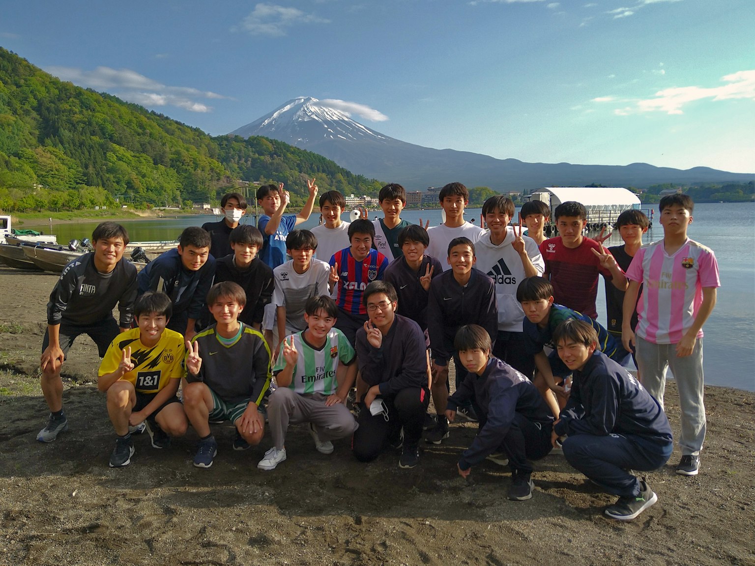 Group photo with Mount Fuji in the background men posing and smiling
