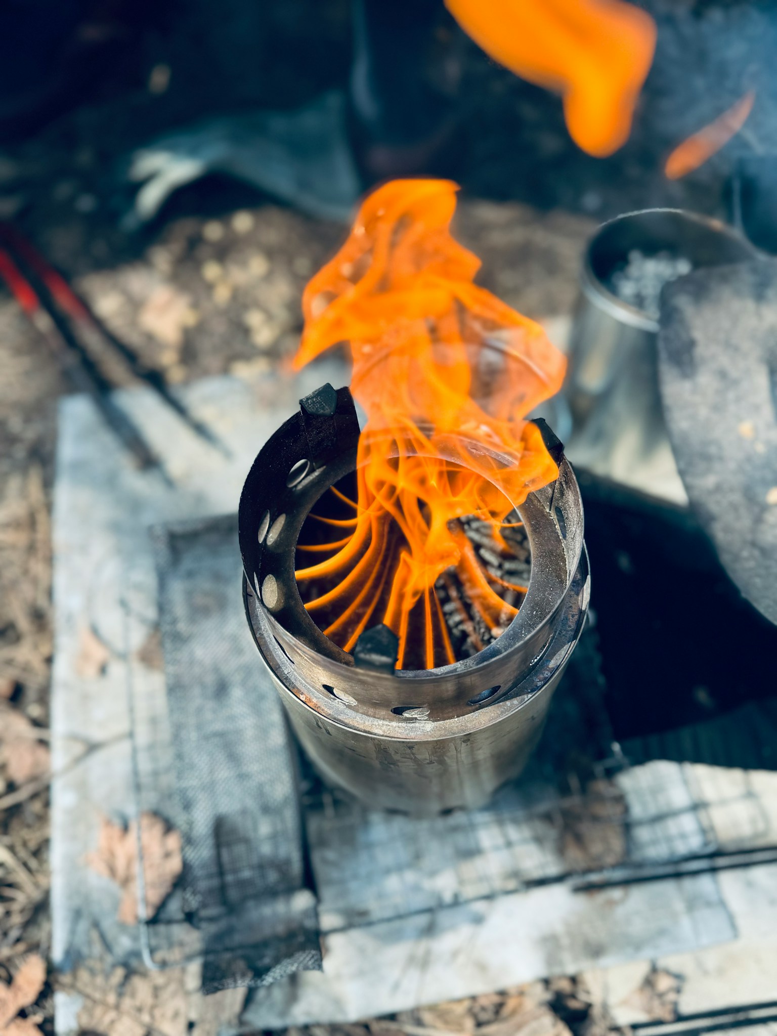 Photo of a metal stove with orange flames burning on top