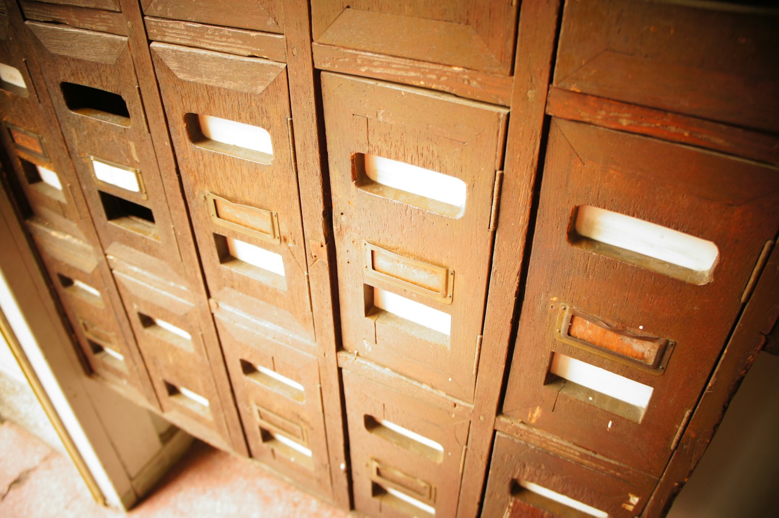 Row of vintage wooden mailboxes with slots