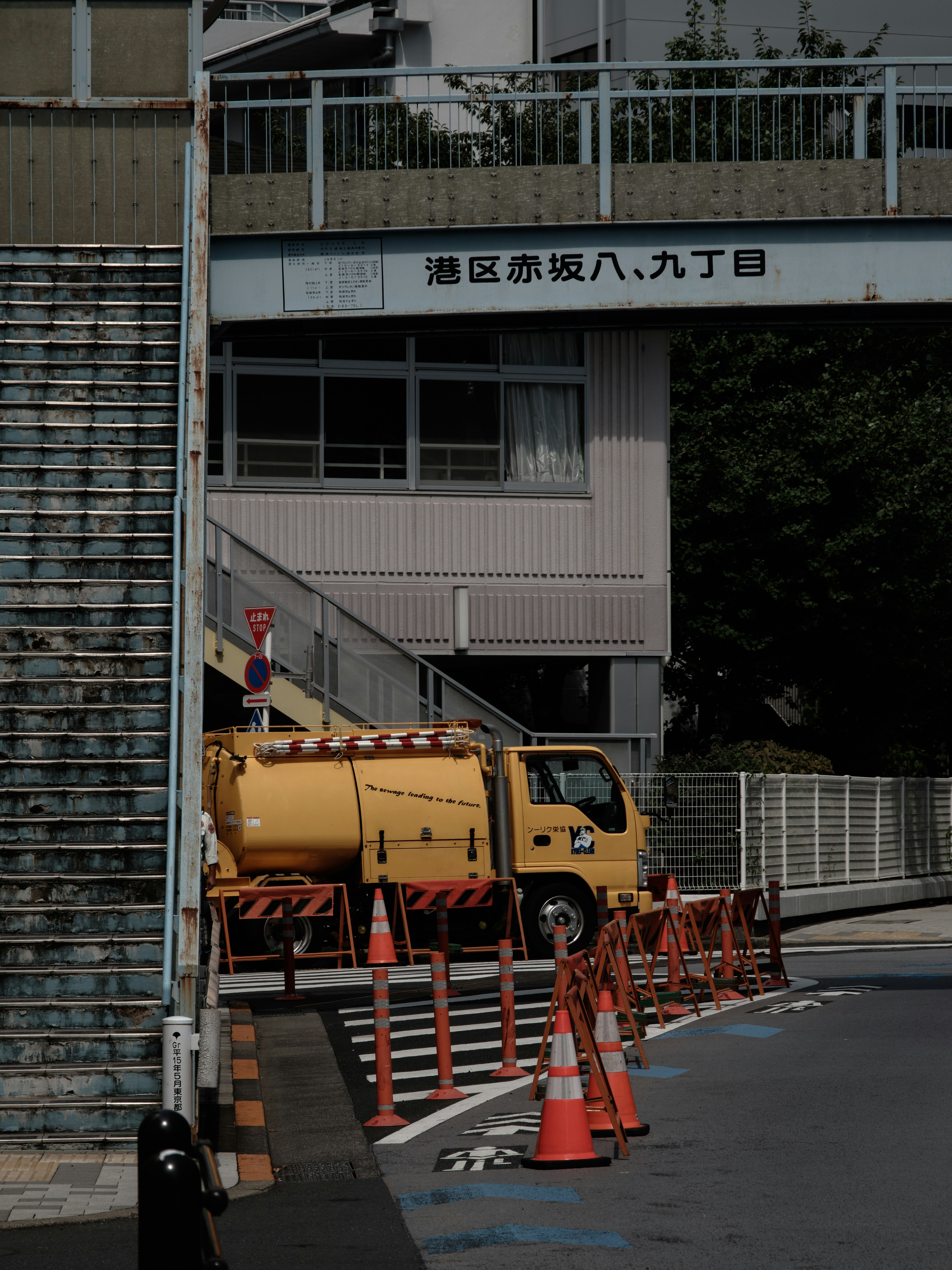 Tokyo cityscape with a pedestrian overpass and work vehicle