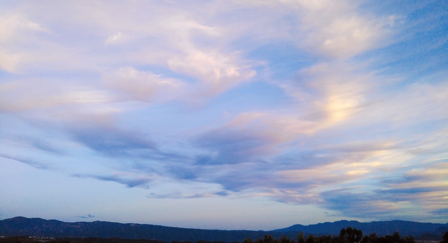 Serene blue sky with soft clouds in the landscape
