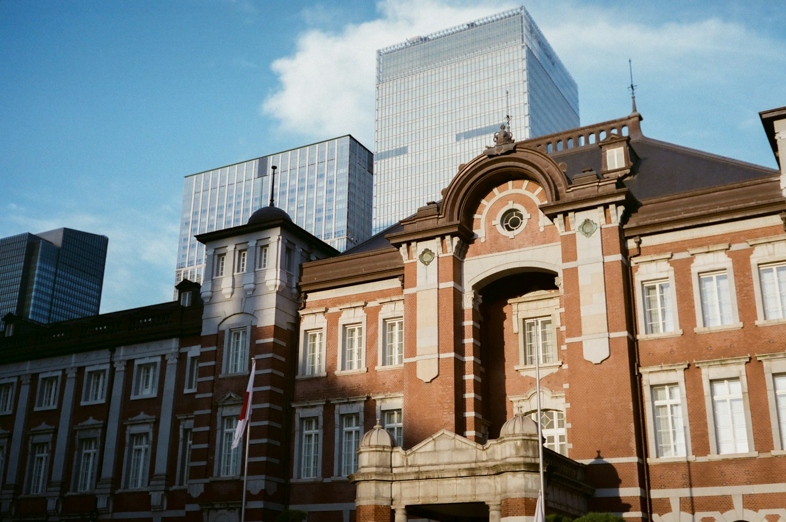 Historic Tokyo Station building contrasted with modern skyscrapers