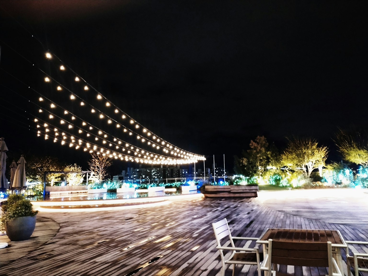 Outdoor space at night with beautiful lighting plants and furniture creating a relaxed atmosphere