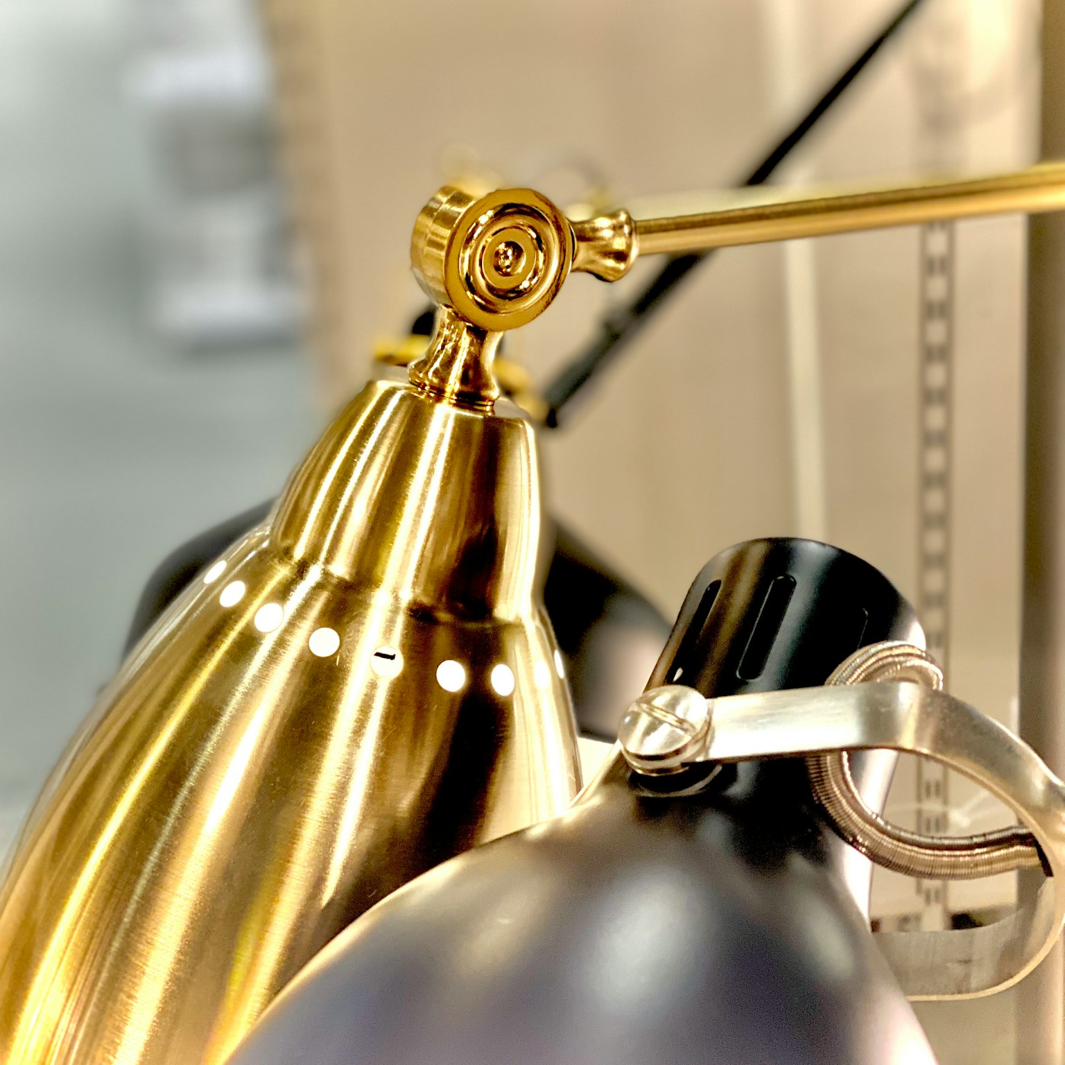 Image featuring a gold lamp and a black lamp in close-up