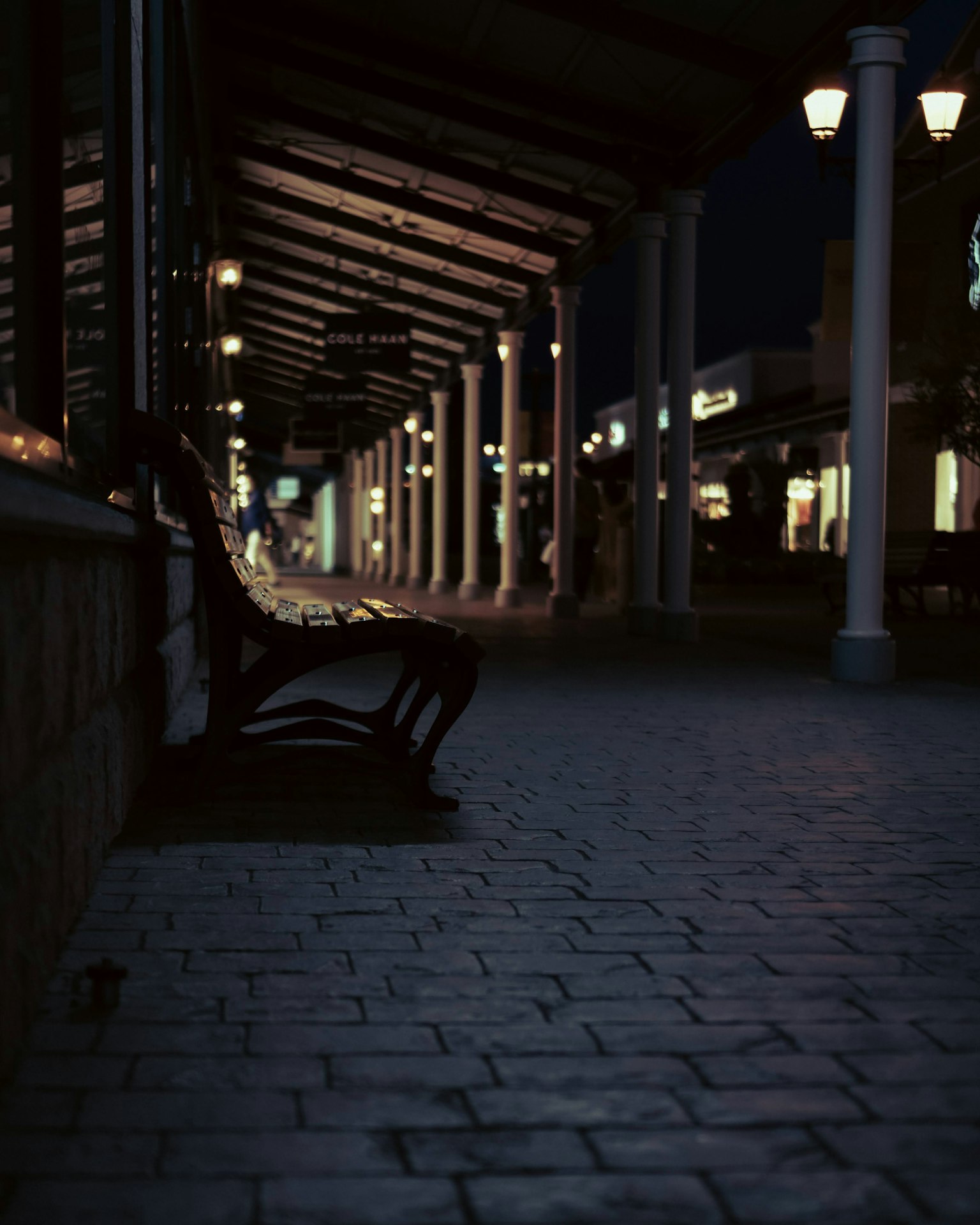 Bench in a commercial area at night with ambient lighting
