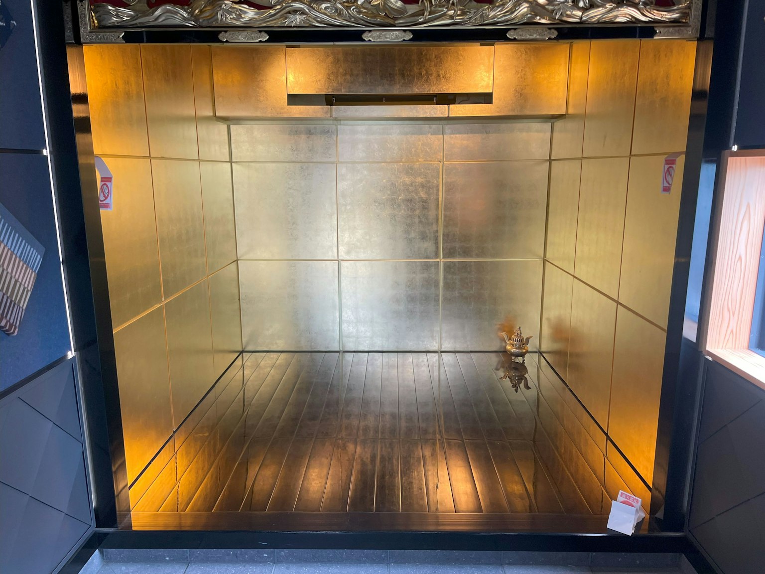 A golden interior space with reflective surfaces and ambient lighting