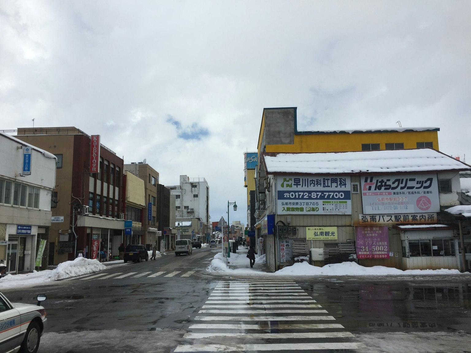 Straßenansicht mit Schnee und Geschäftsgebäuden