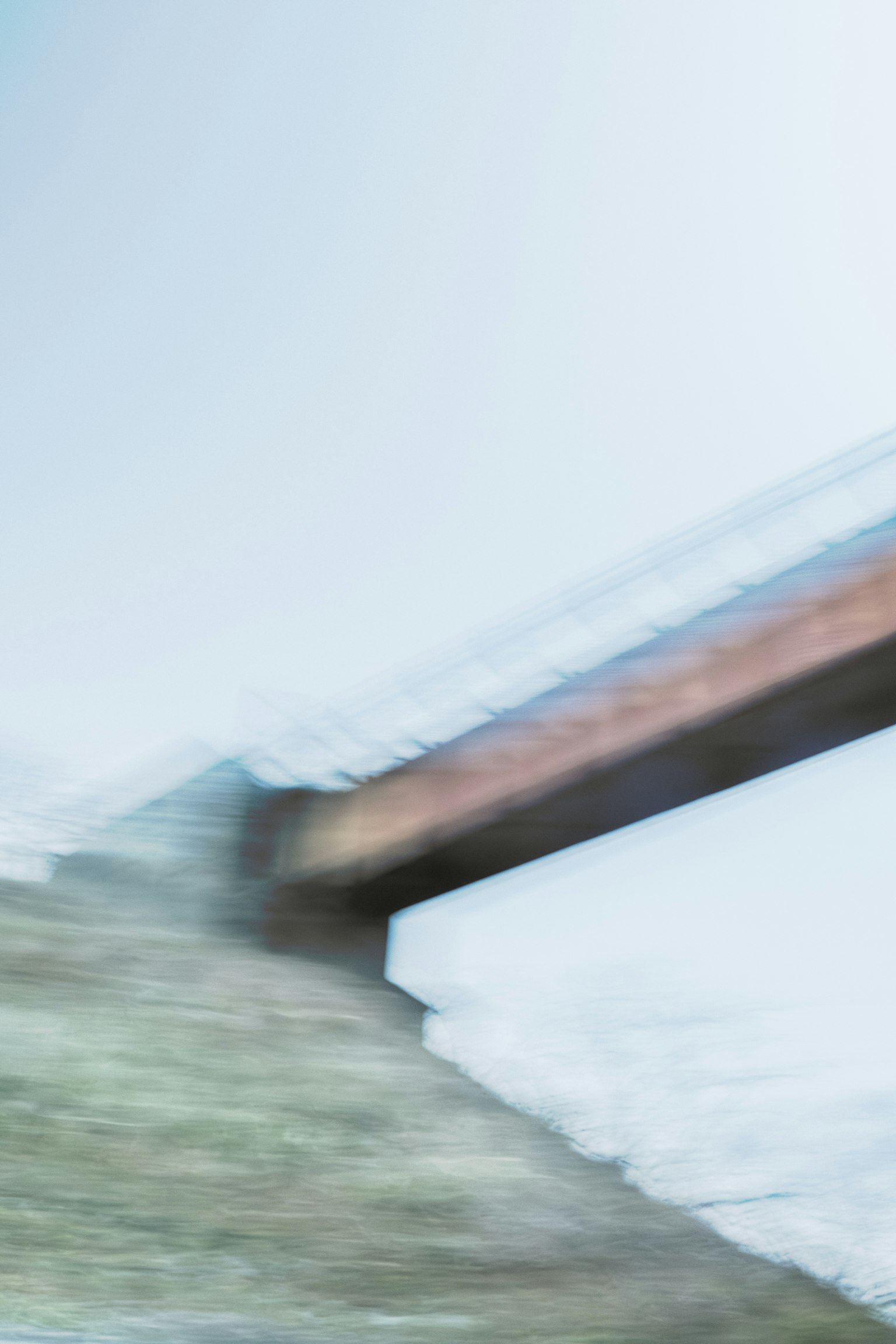Blurred bridge over natural landscape
