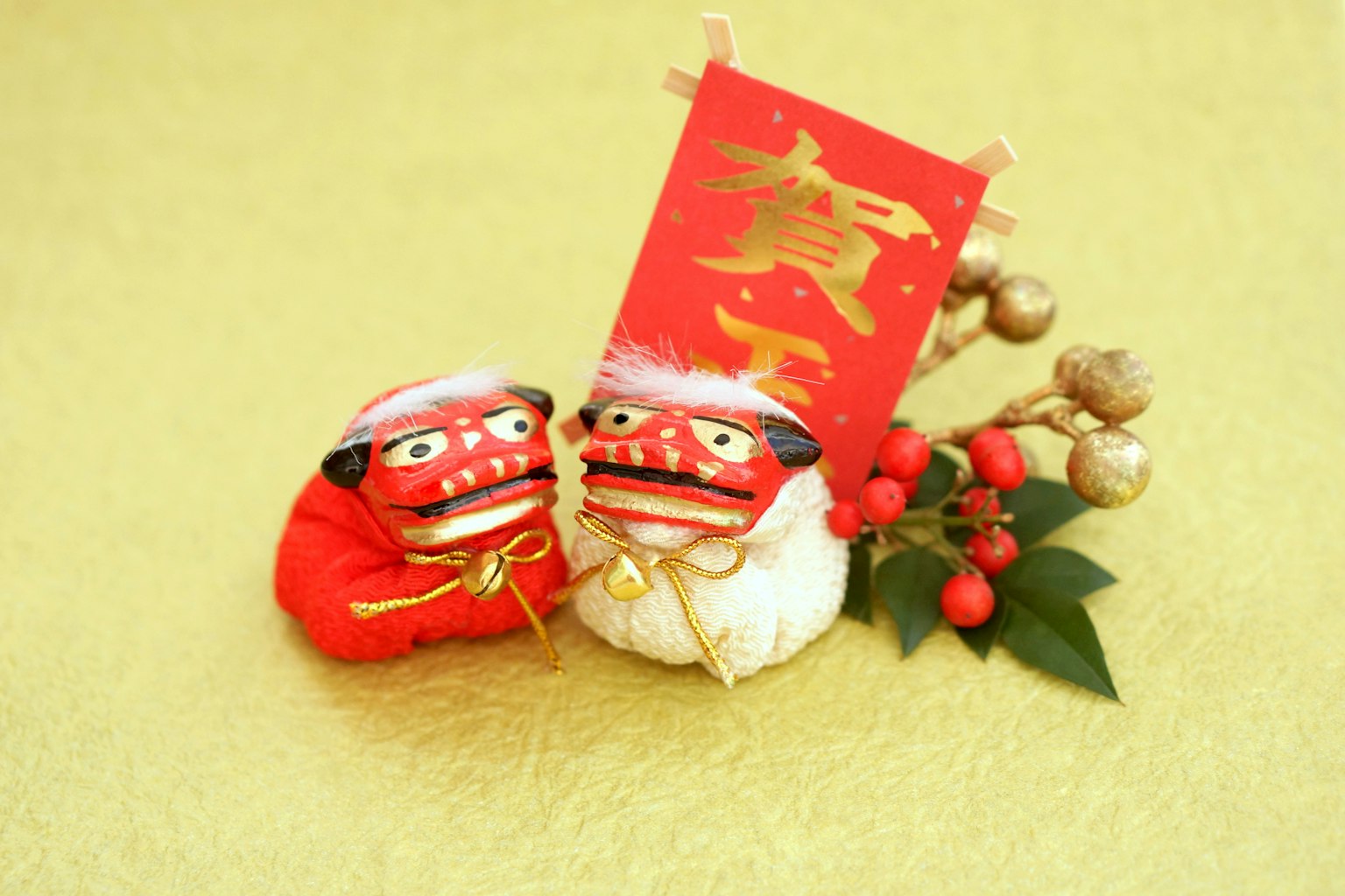 Traditional red and white lion dance decorations placed against a golden background