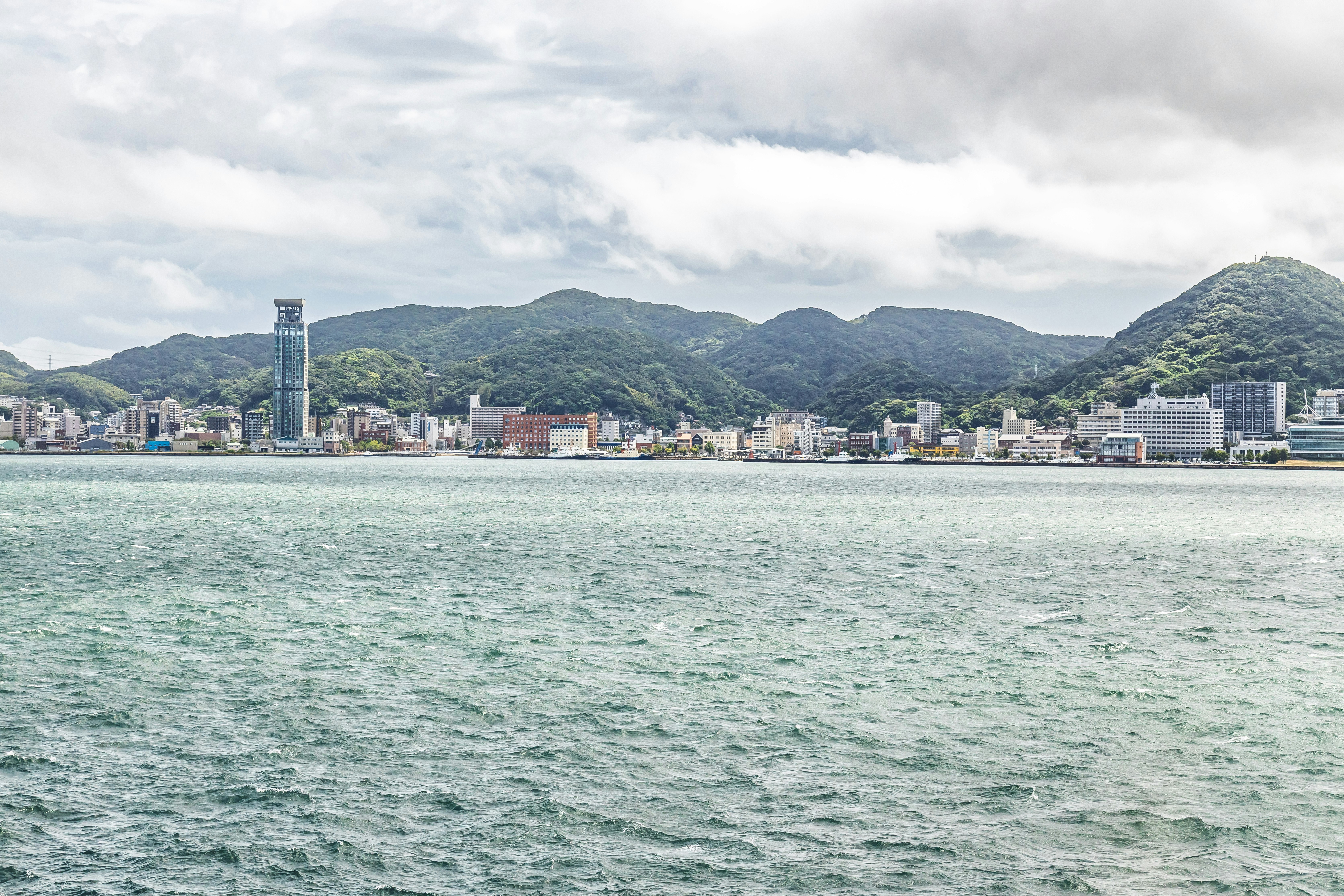 Coastal city view with mountains in the background