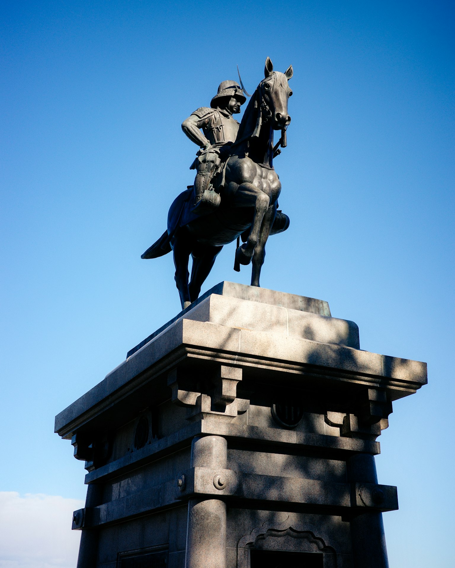 Equestrian statue of a soldier against a blue sky