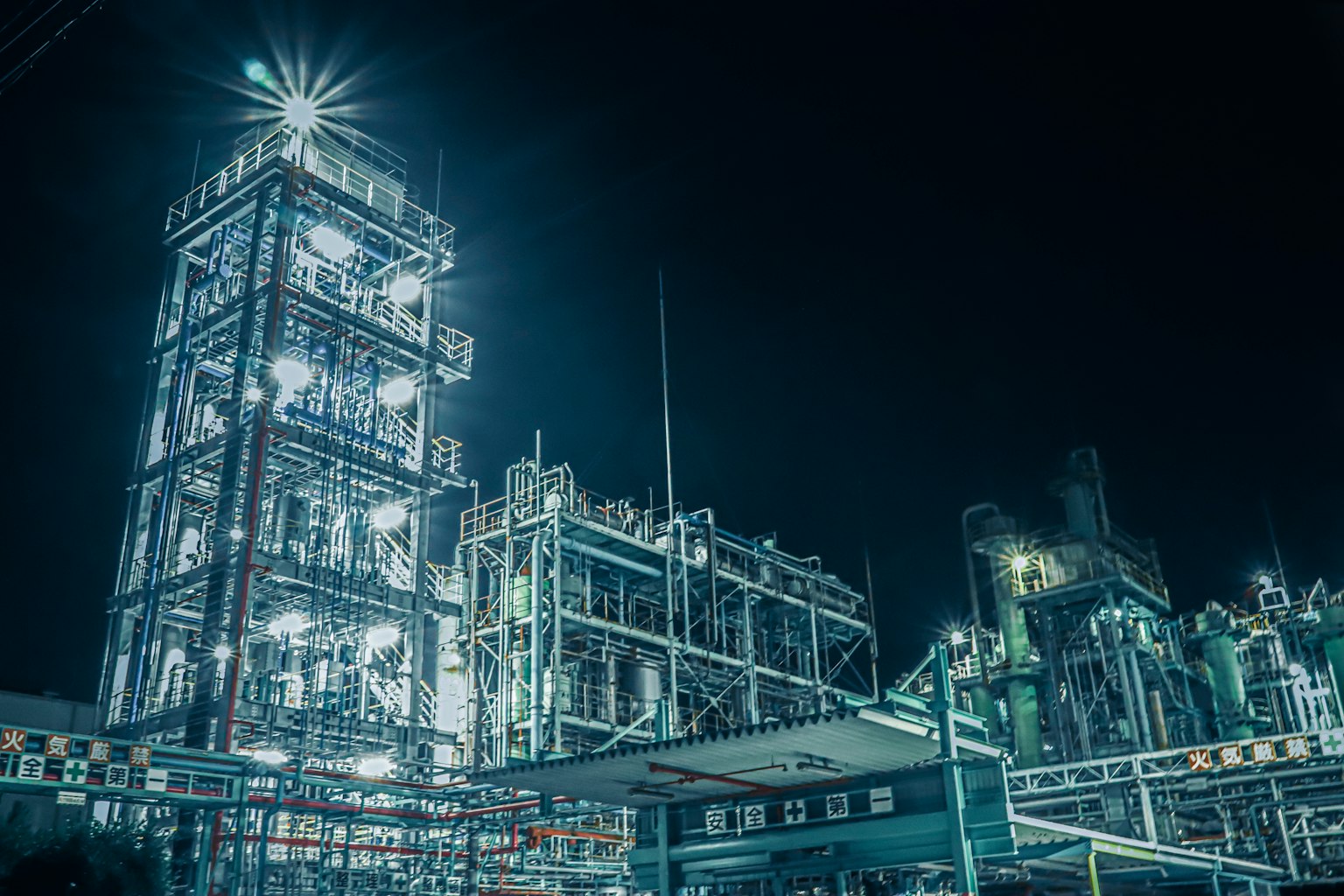 Brightly lit industrial facility at night showcasing intricate structures