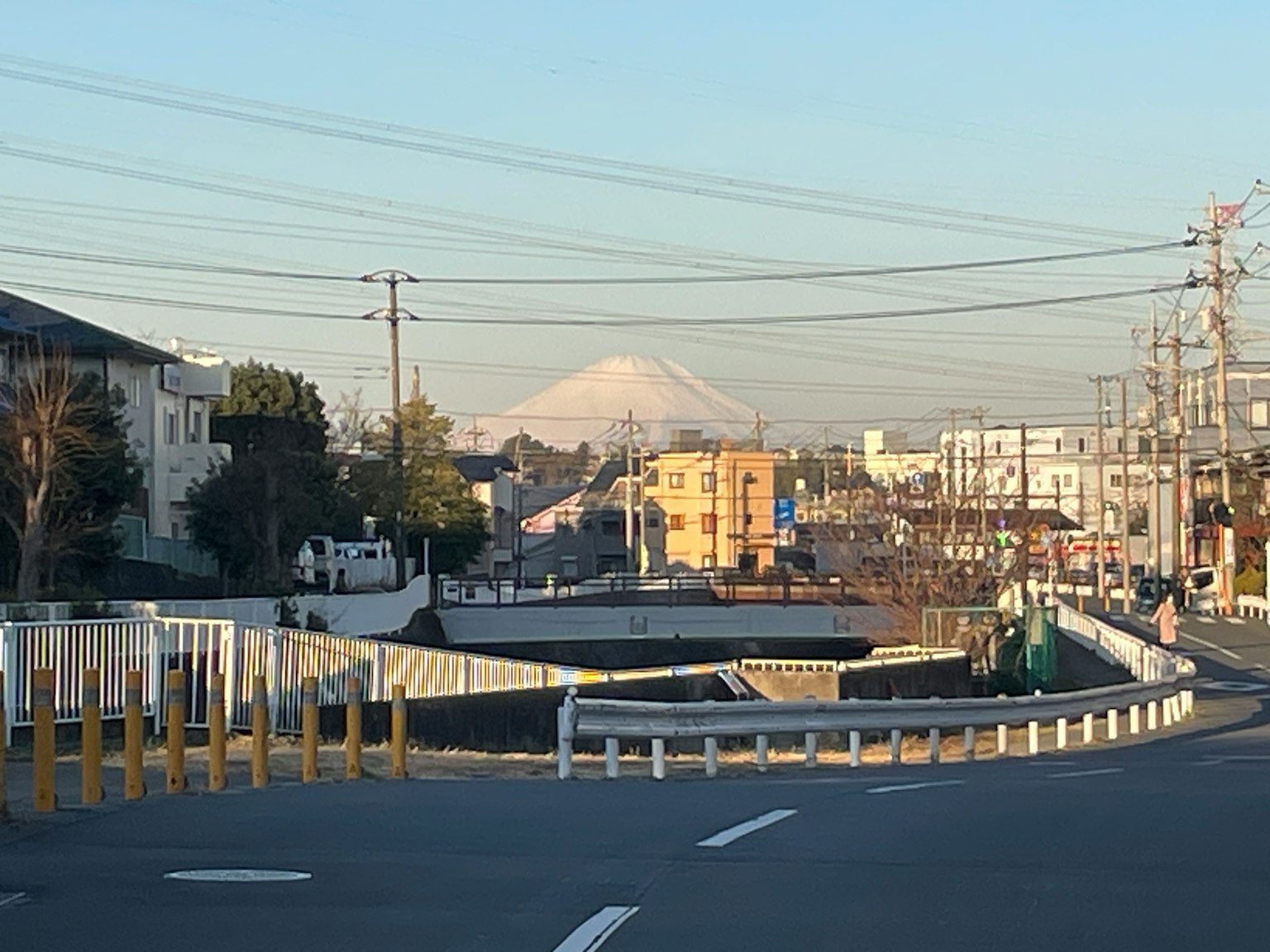 Street view featuring Mount Fuji in the background with utility poles