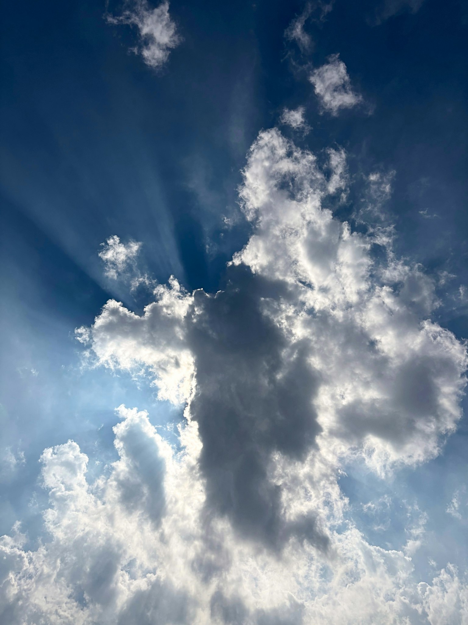 Clouds with rays of light against a blue sky