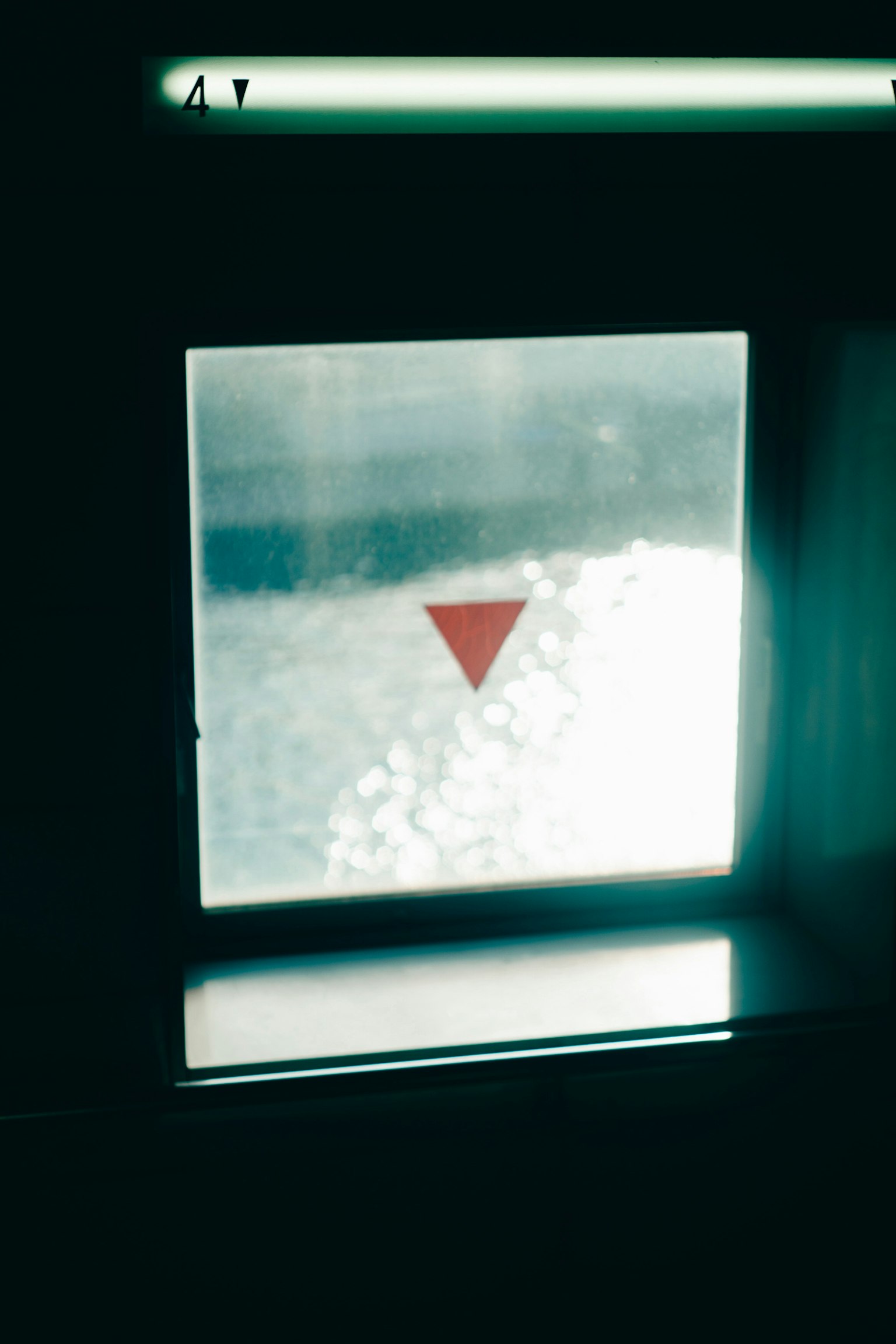 Simple design with a red downward triangle on a blue background