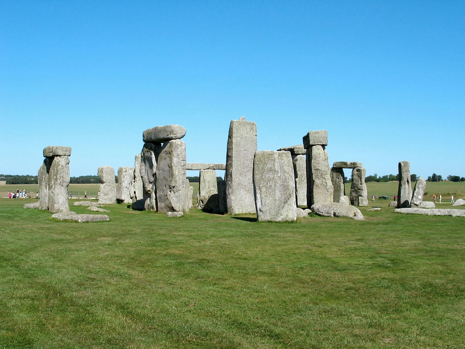 Stonehenge stone monument under a clear blue sky