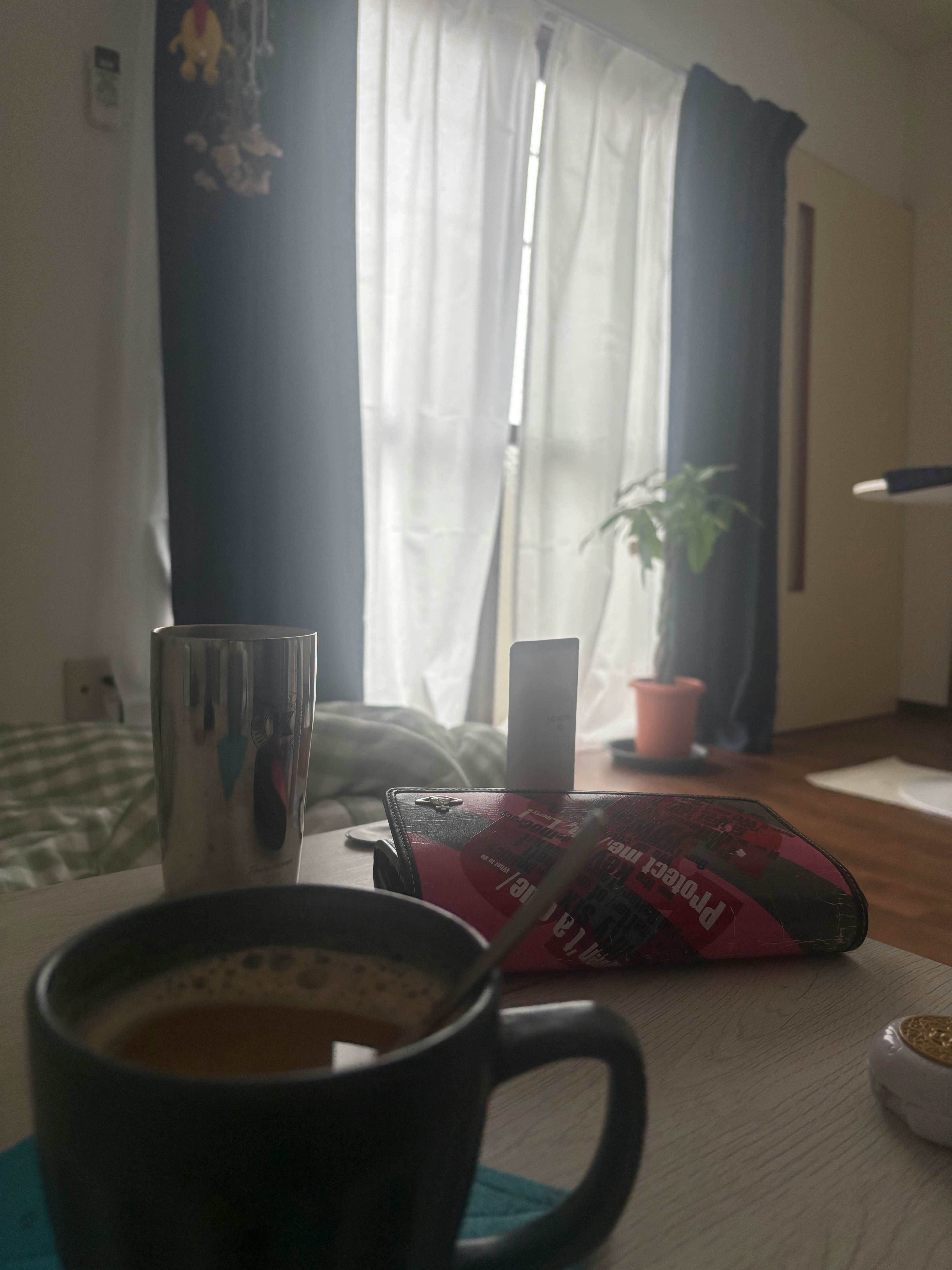 Coffee and books on a table by a window in a room