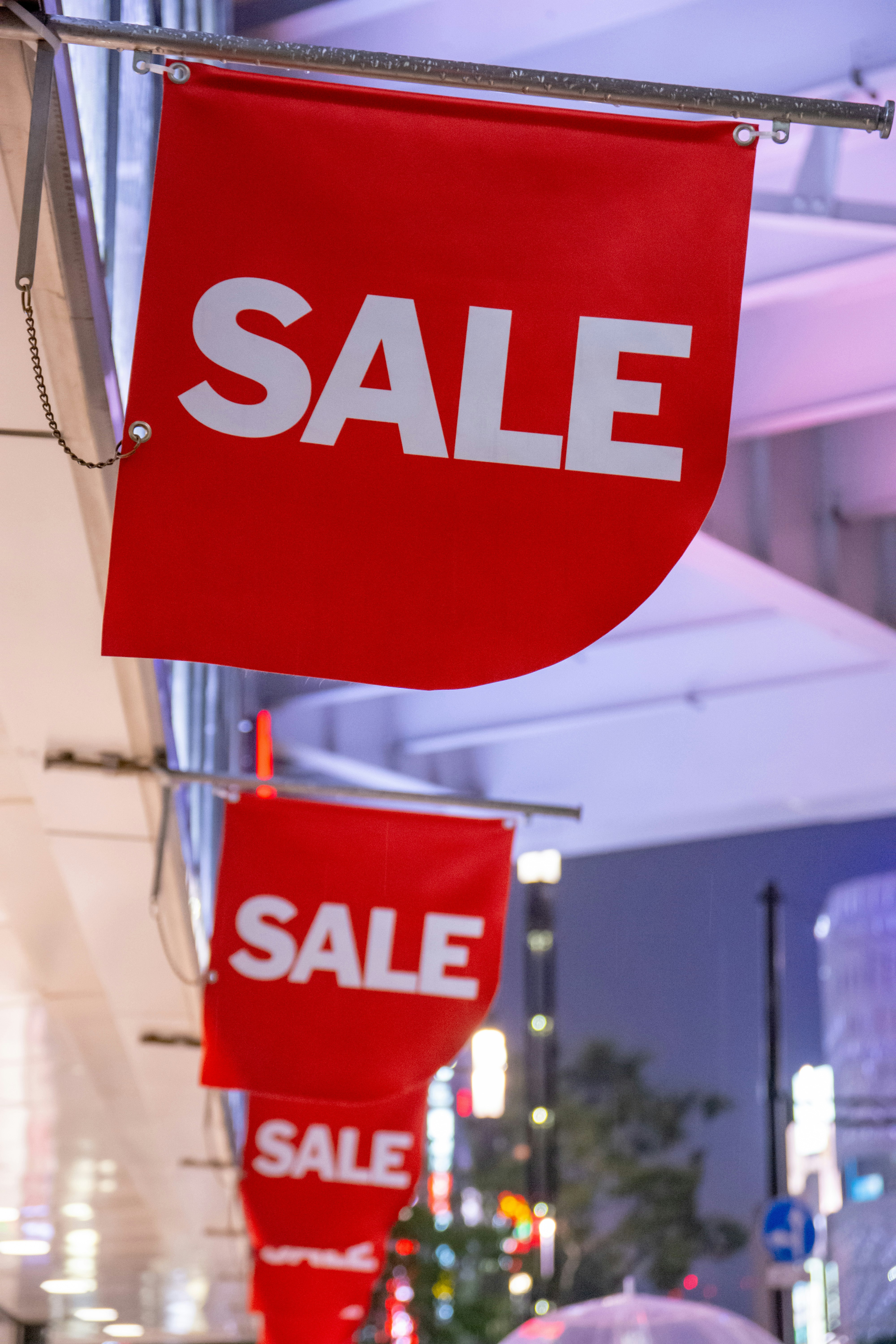 red SALE banners hanging on a street