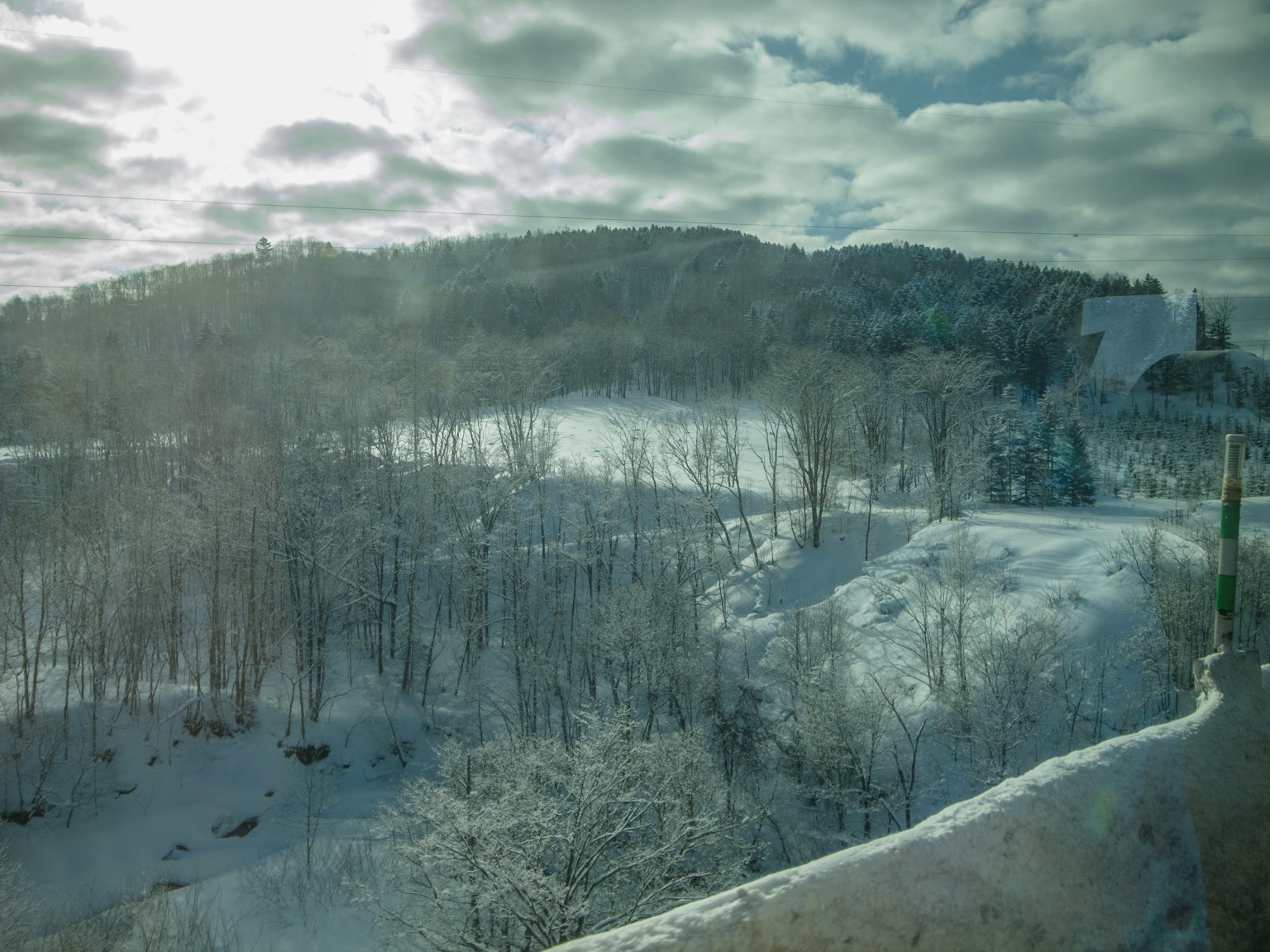 Paysage couvert de neige avec un ciel lumineux et des nuages