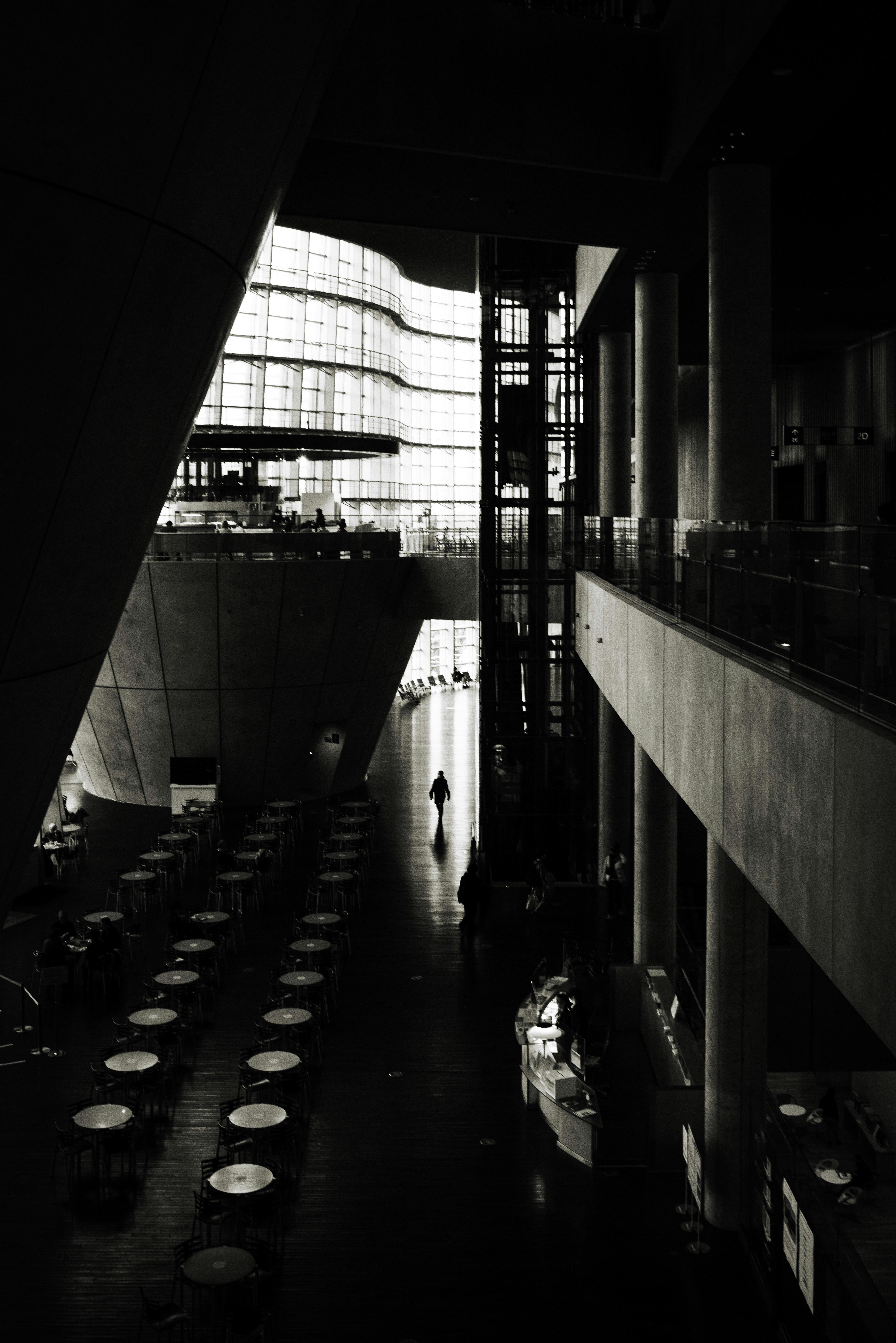 indoor corridor with black arches and rows of circular lights