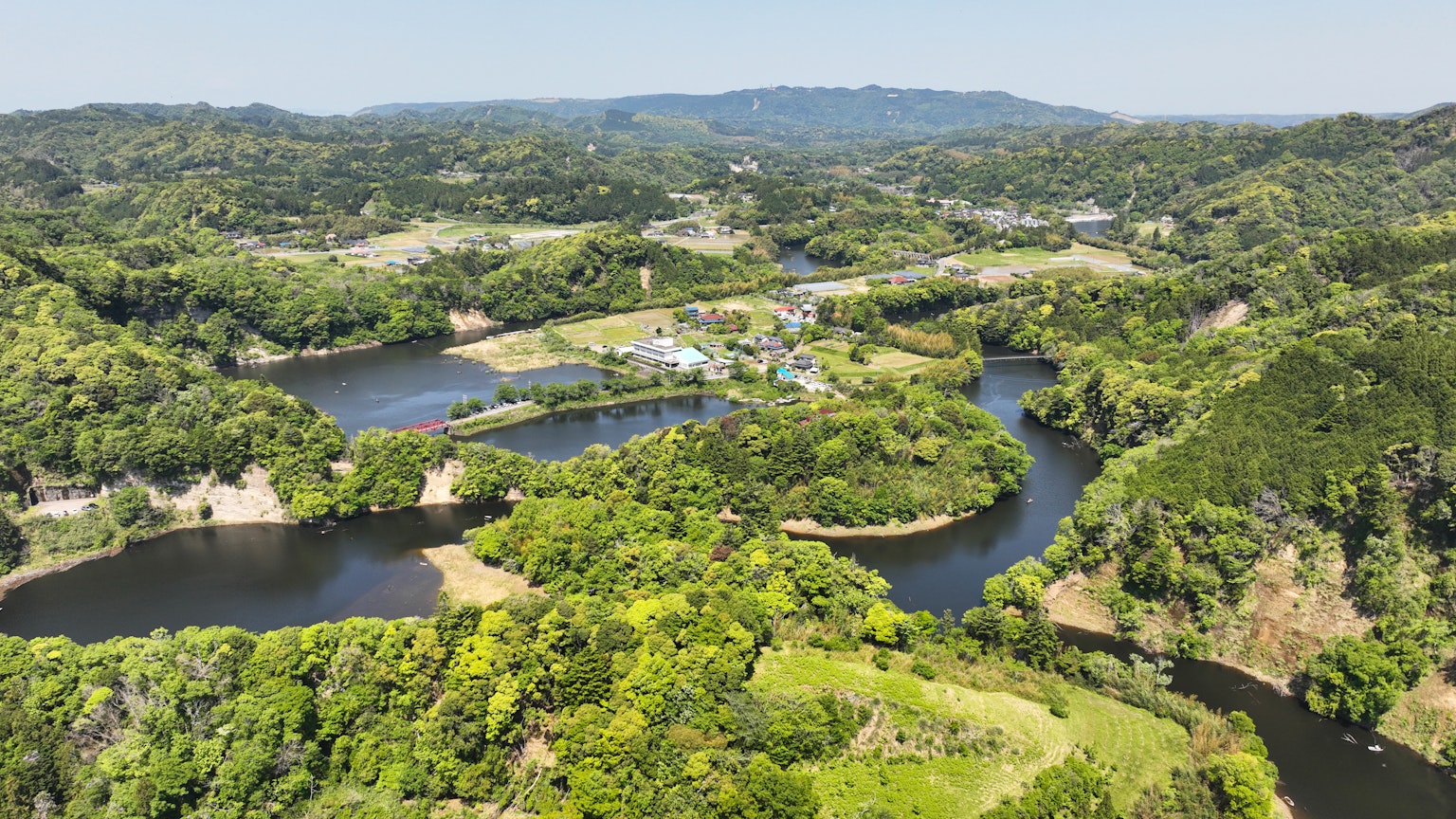 Aerial view of a lush landscape featuring winding rivers and greenery