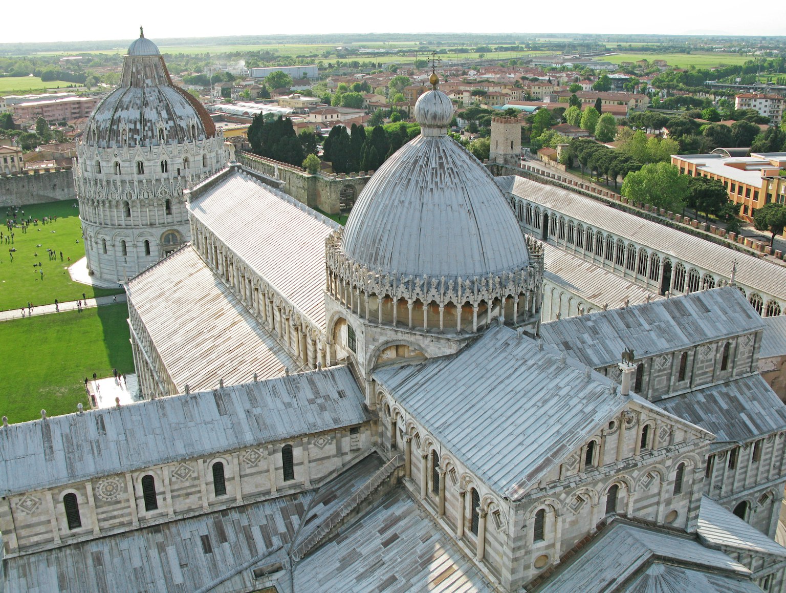 Aerial view of Pisa Cathedral showcasing its distinctive domes and lush green landscape
