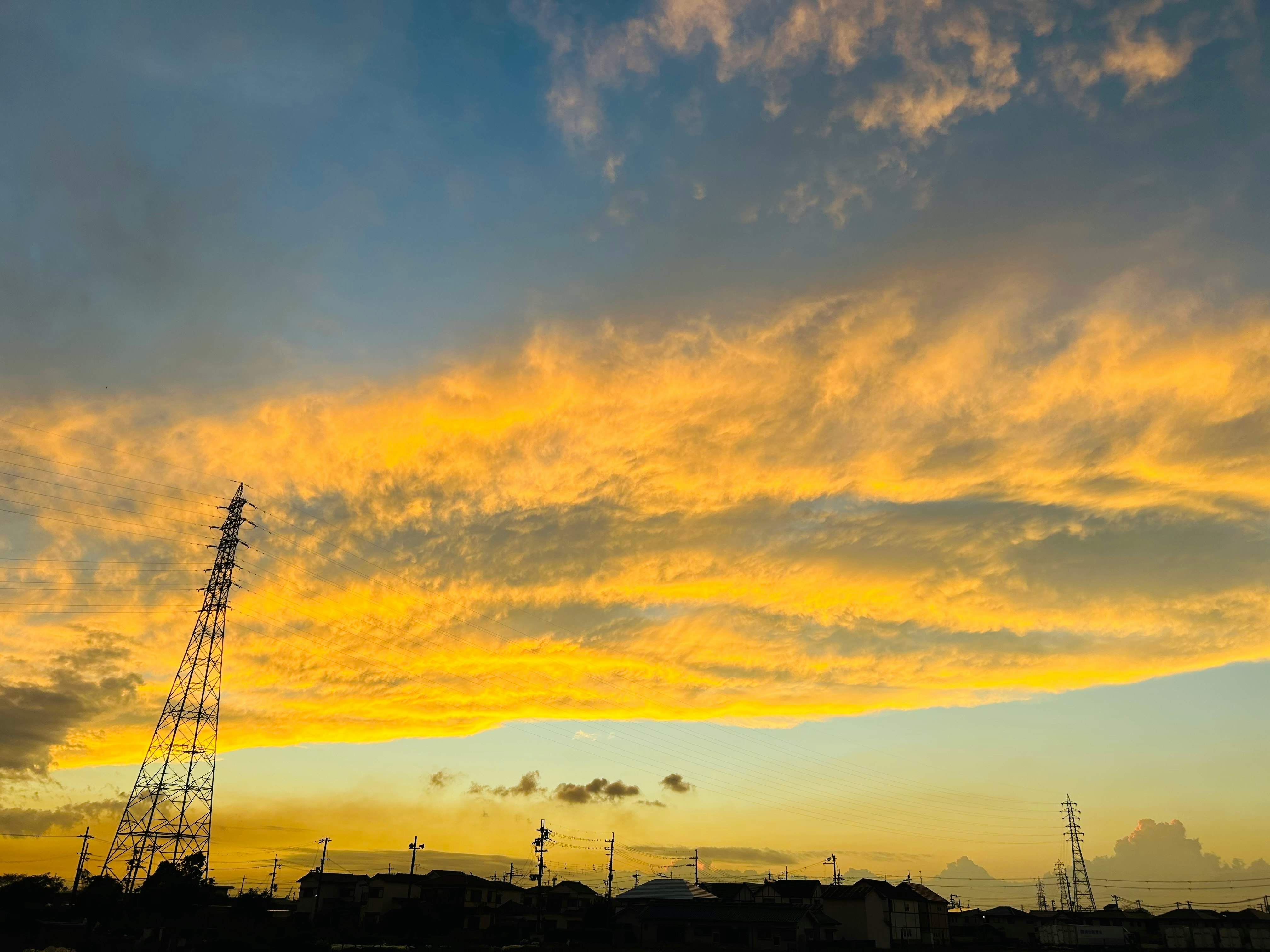 Stadt-Skyline-Silhouette mit Kränen unter einem Sonnenuntergangshimmel