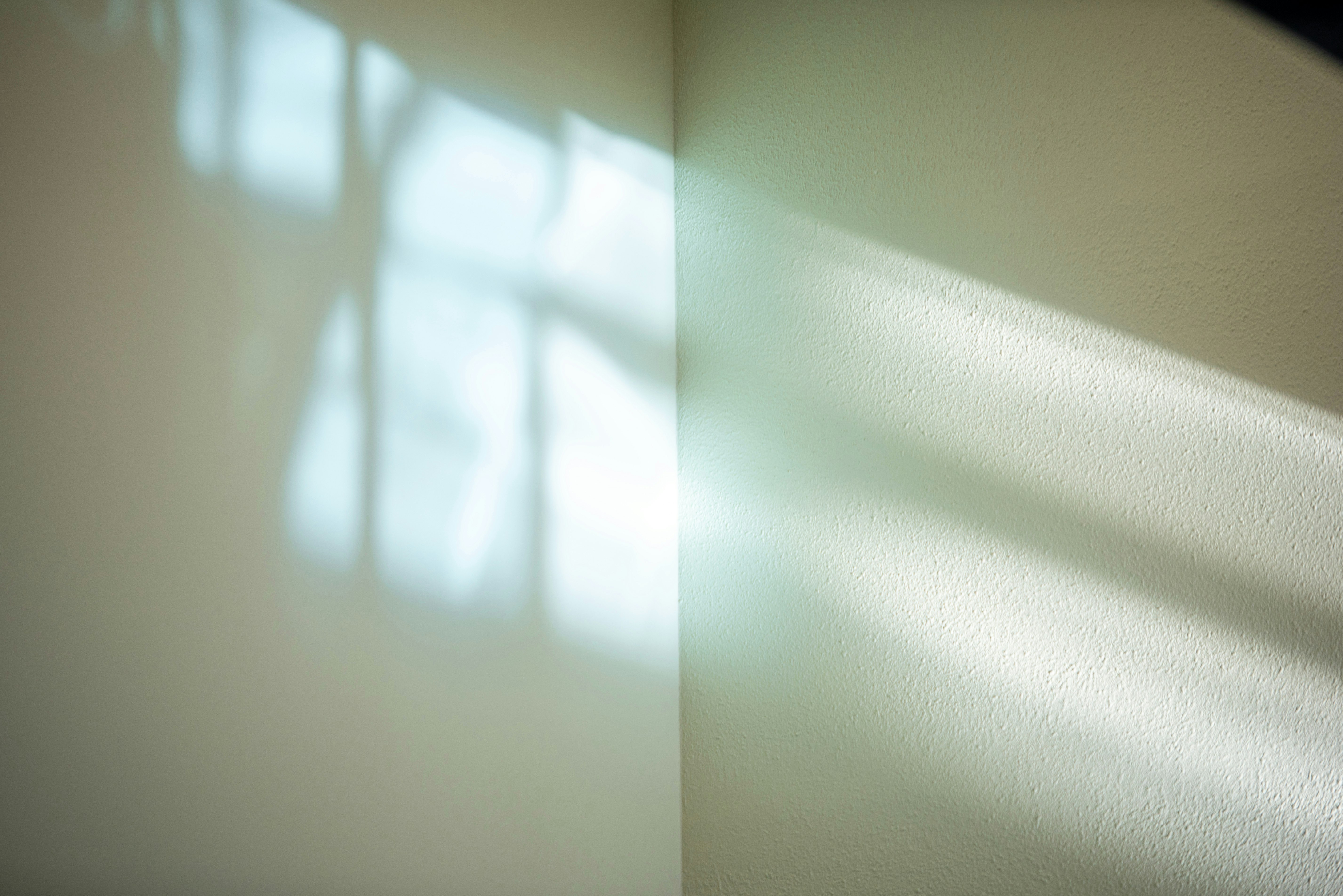 abstract shadows on a wall from window light