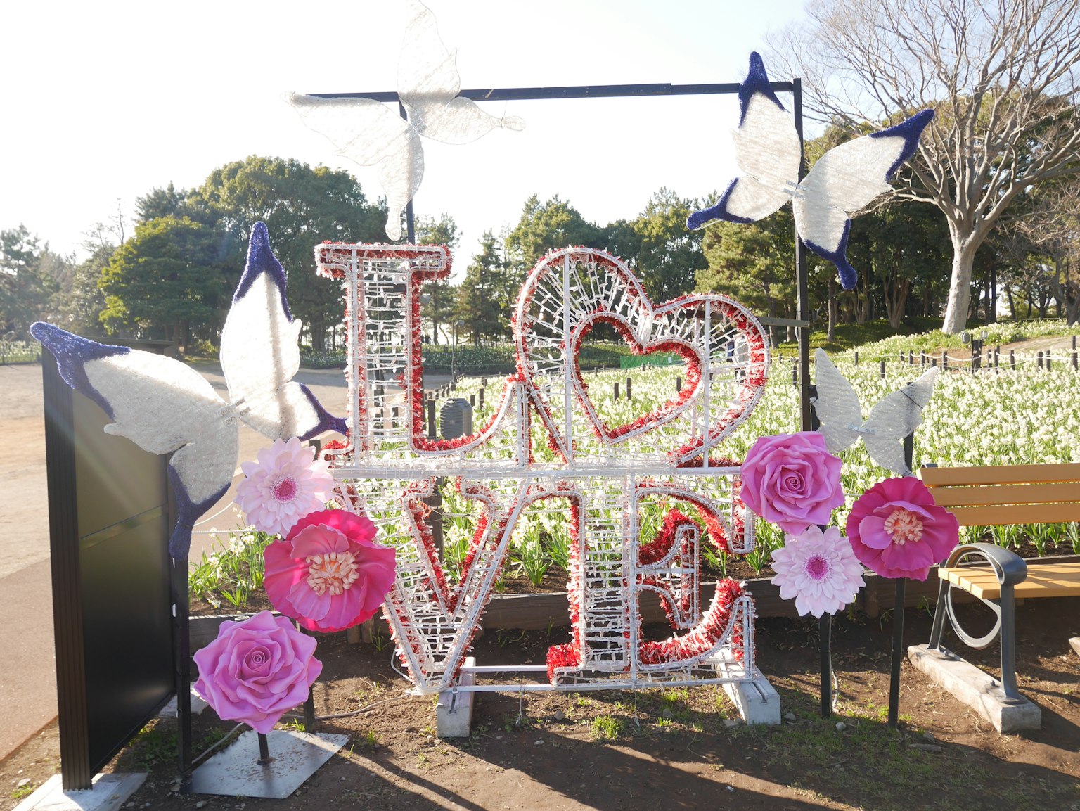 Decorative 'LOVE' sign in a park with colorful flowers