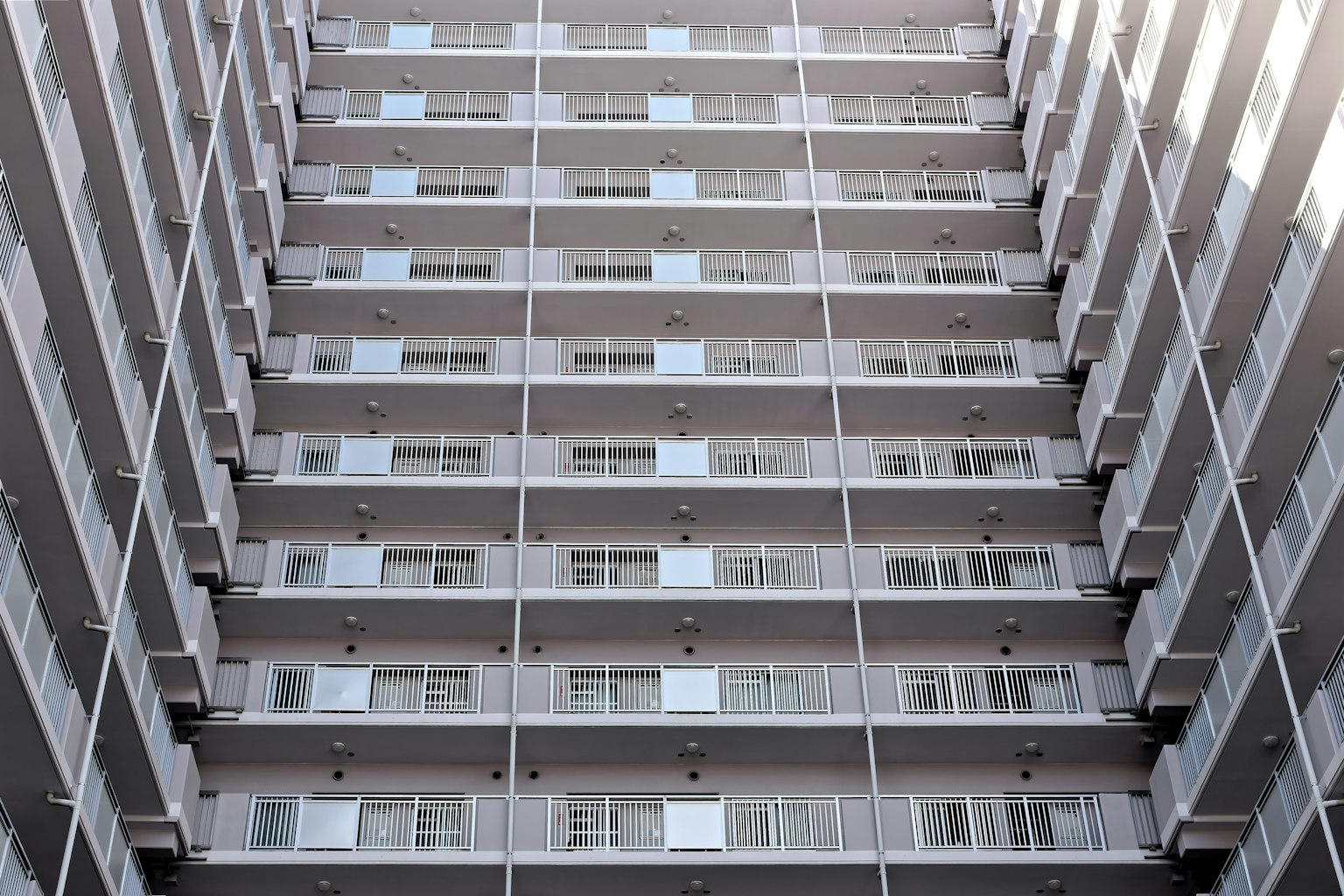 Image of a high-rise building showcasing multiple balconies and windows
