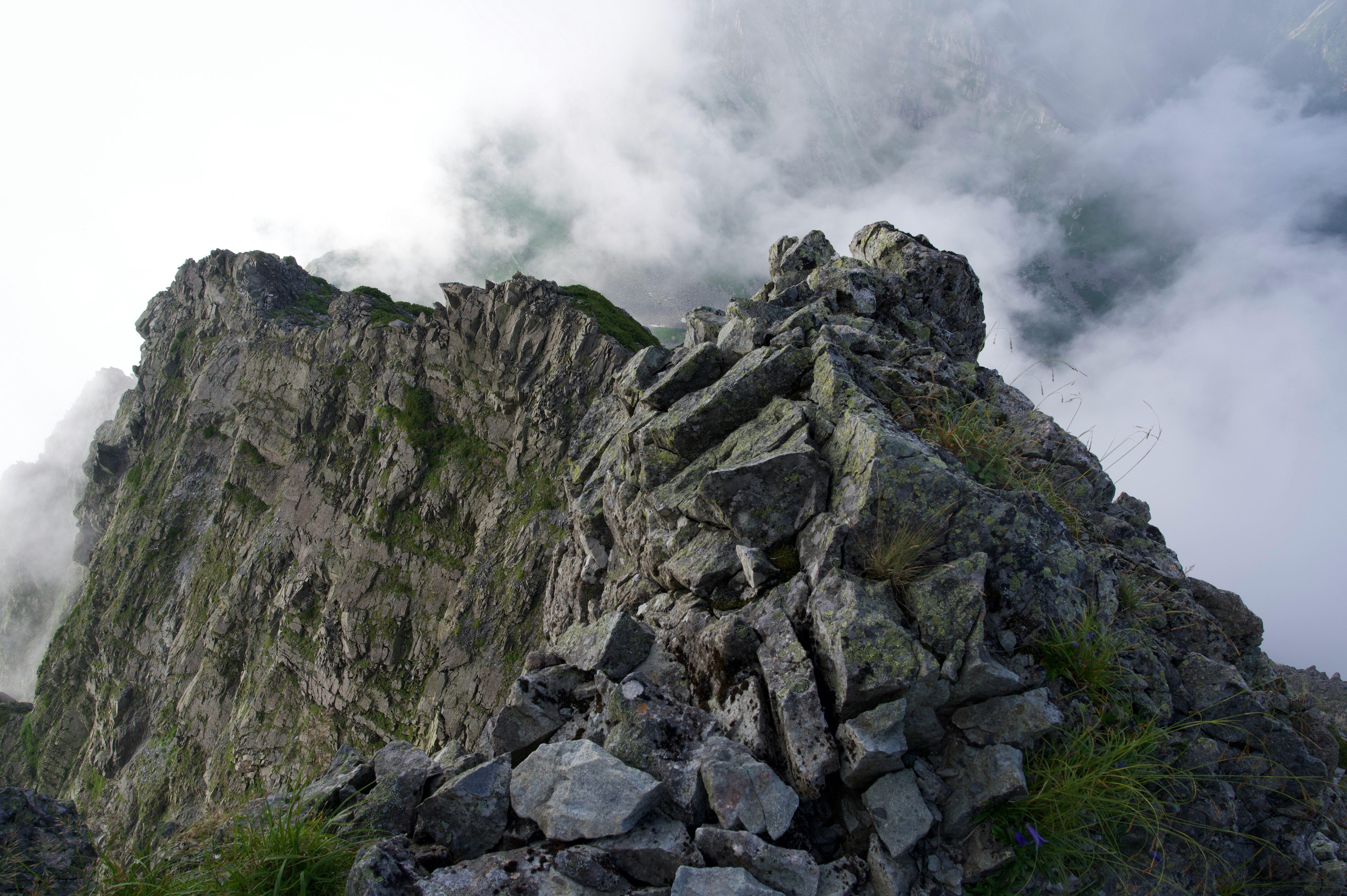 rocky mountain summit with cloud-covered ridgeline