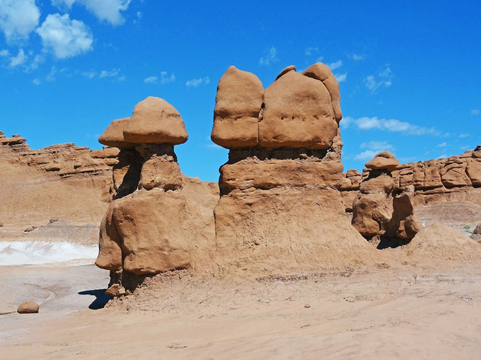 Landscape of unique rock formations in Utah with blue sky and clouds