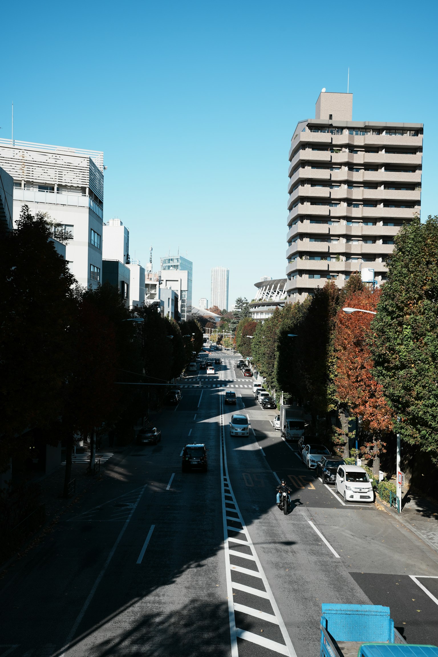 ทิวทัศน์ถนนในเมืองที่มีอาคารสูงและท้องฟ้าสีฟ้าสดใส
