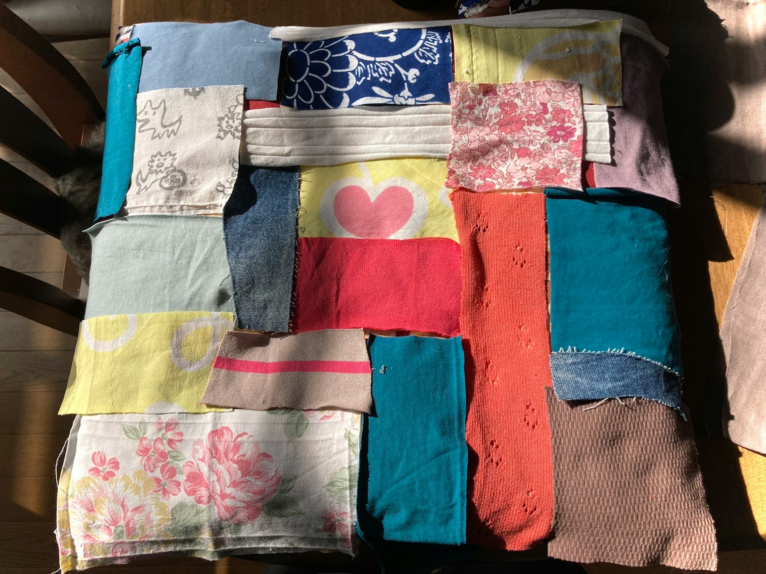 Colorful patchwork fabric arrangement with various patterns and textures