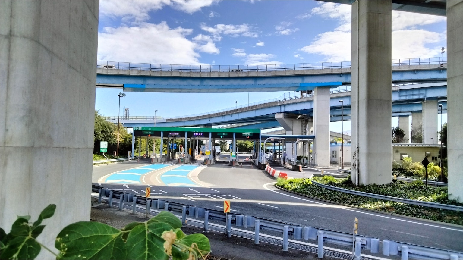 Intersection under elevated highway with blue sky