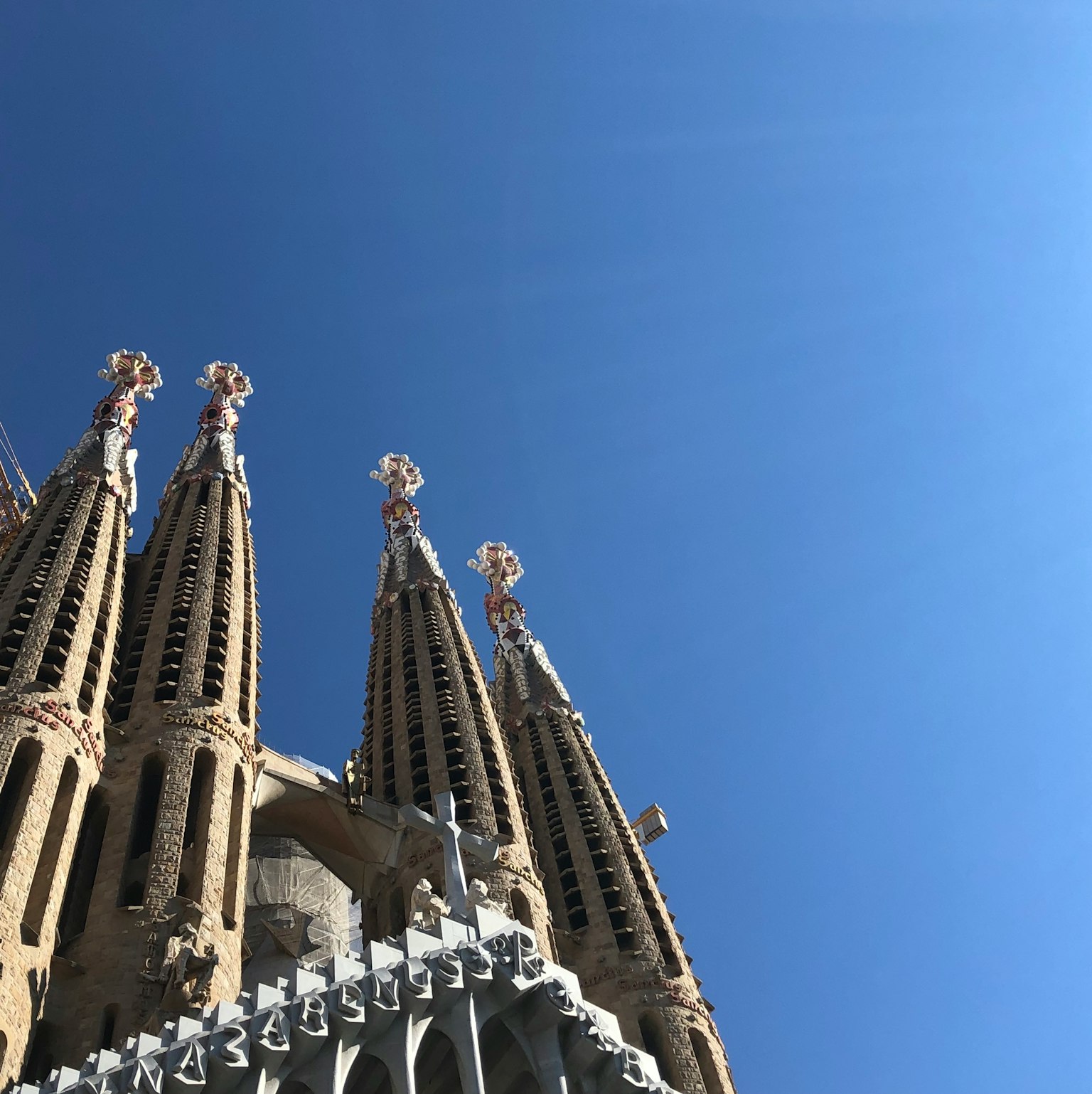 Sagrada Familia spires towering under a clear blue sky