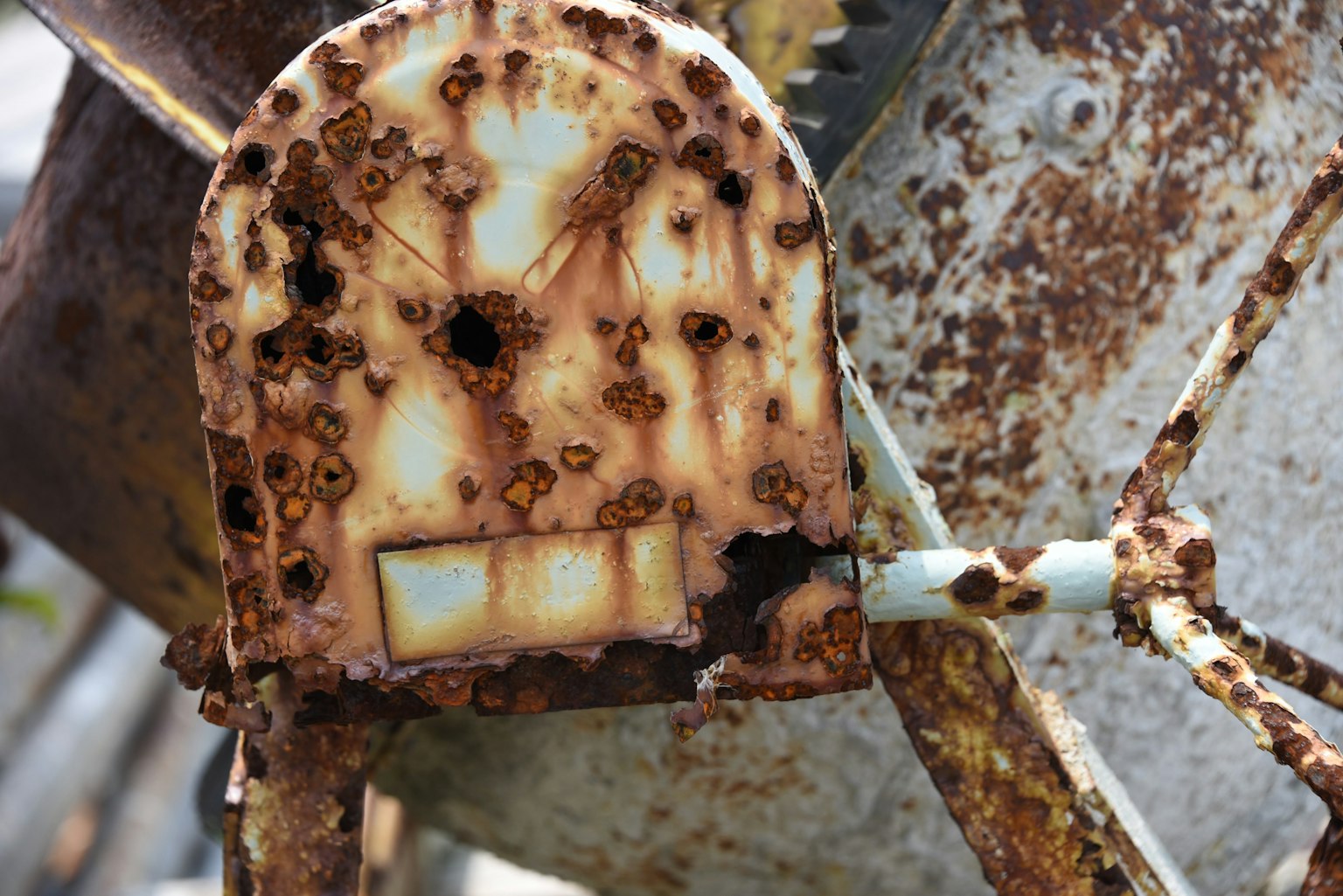 Close-up of a rusty machine part featuring an old design and unique texture