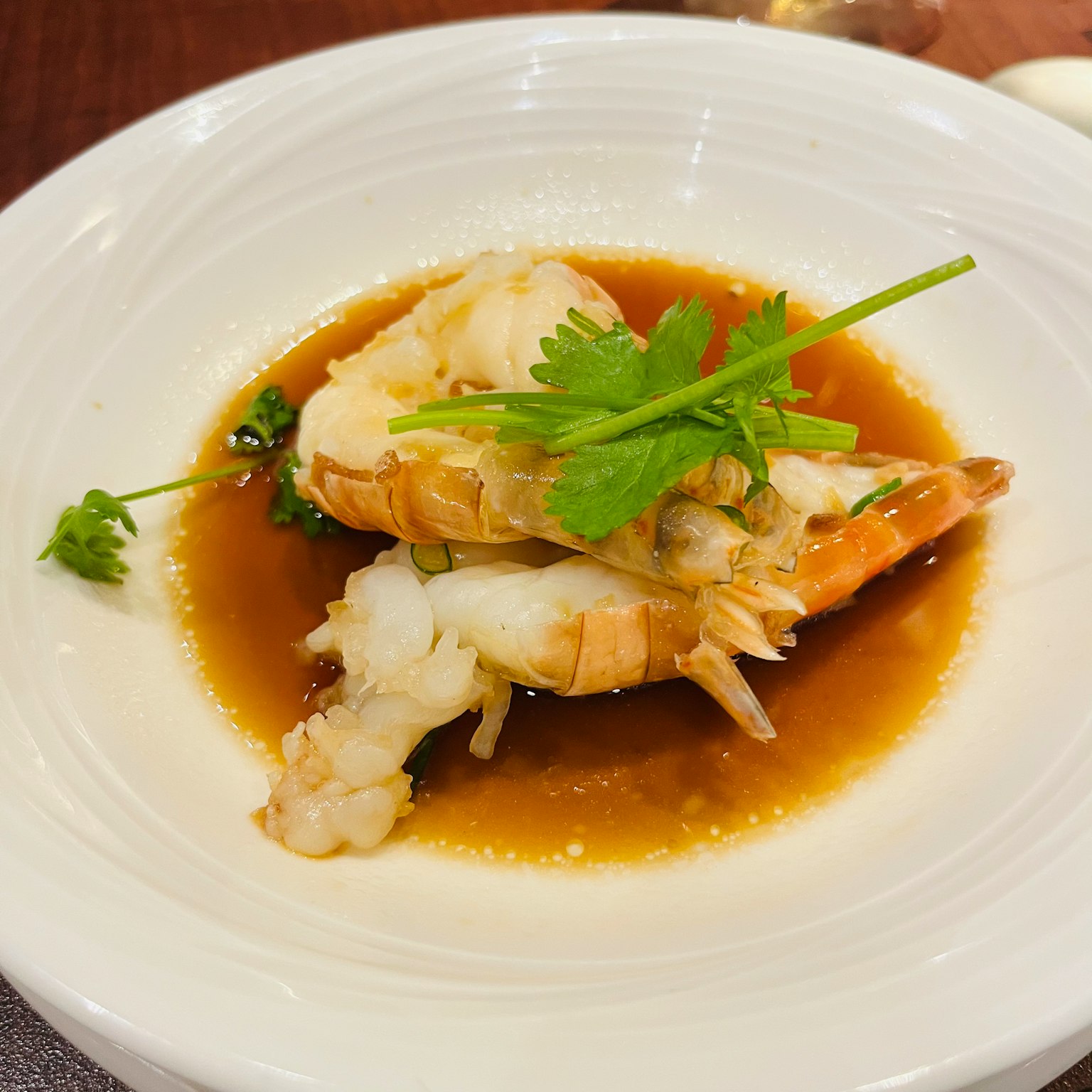 Plato de camarones delicioso presentado en un plato blanco adornado con hierbas