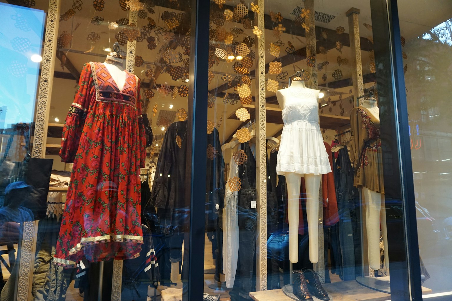 Fashion store window display featuring a red dress and a white dress