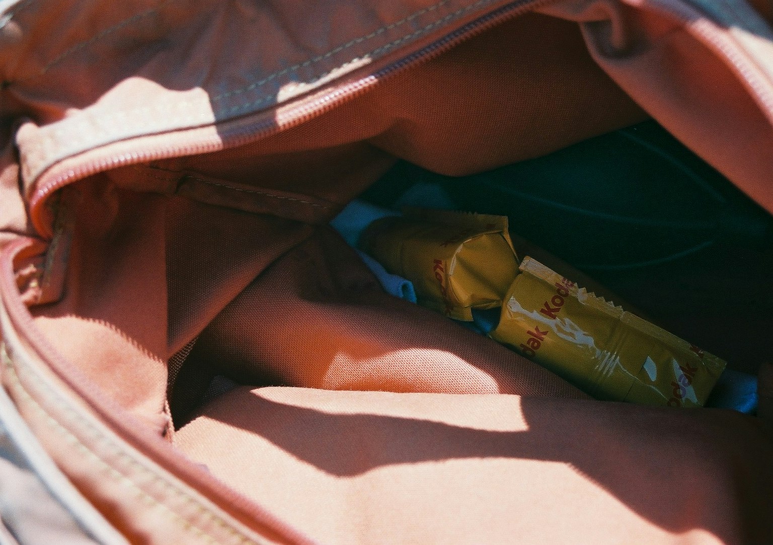 Interior of an orange backpack showing a yellow package
